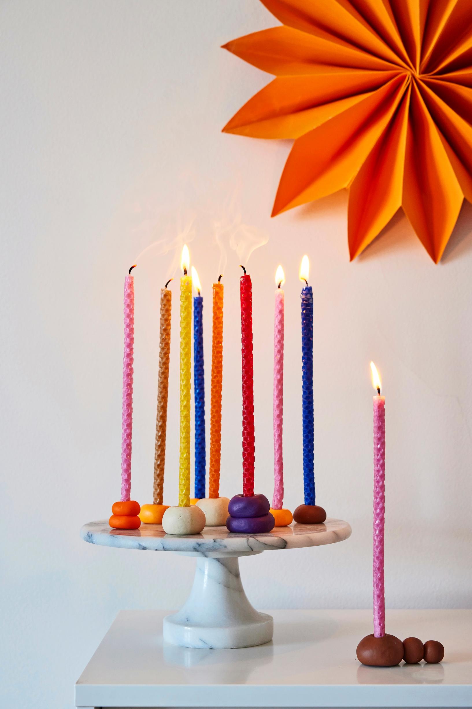 Colorful long, slender cake candles made from beeswax honeycomb sheets.
