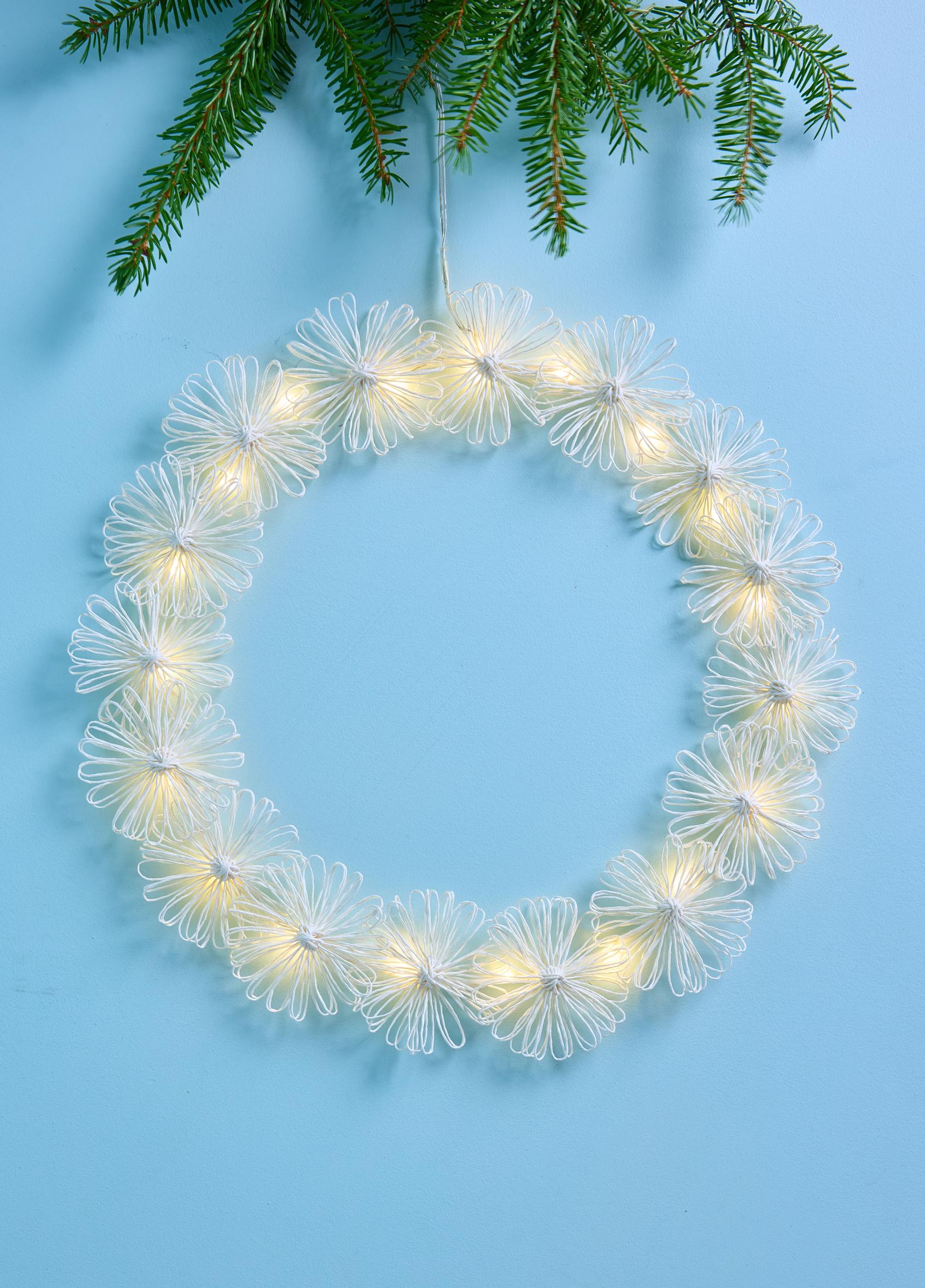 Turn paper twine into a glowing wreath with string lights
