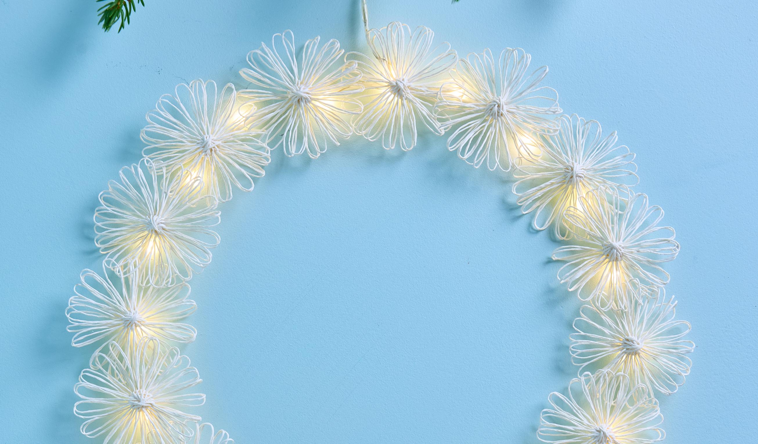 Turn paper twine into a glowing wreath with string lights