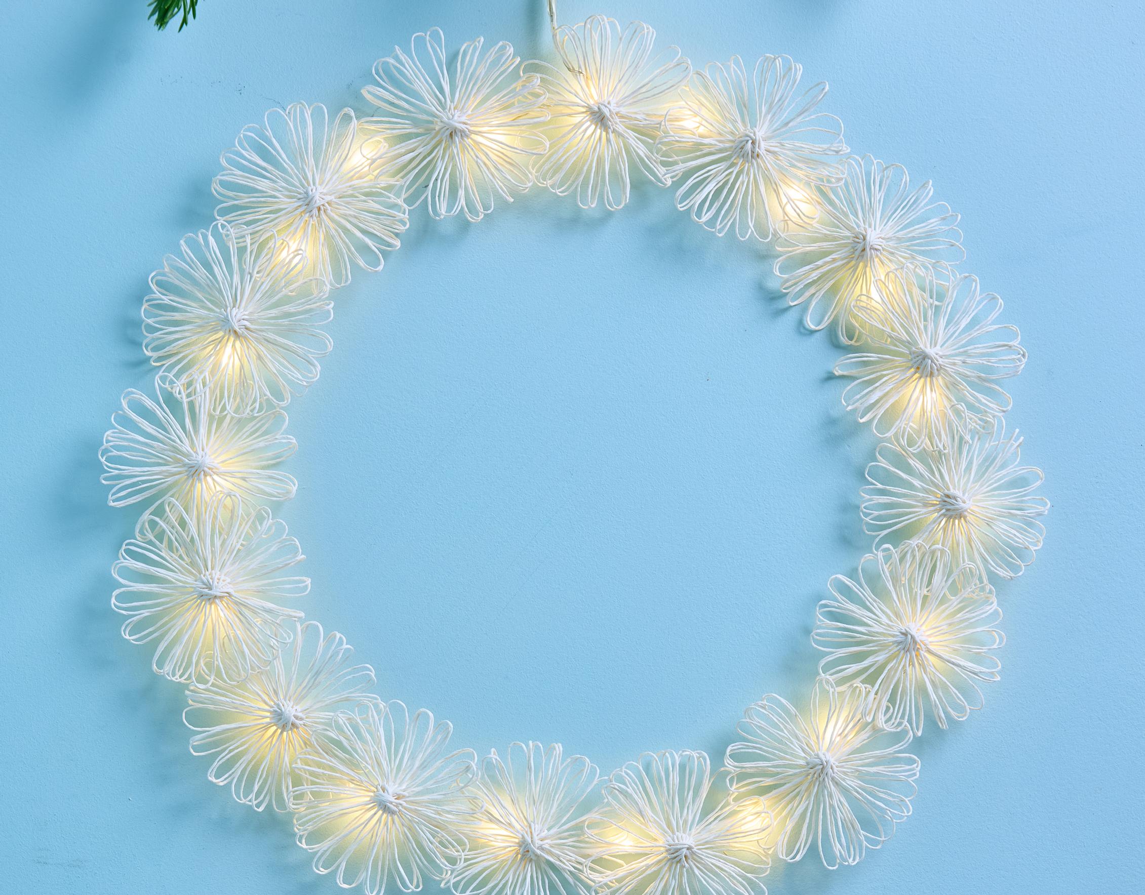 Turn paper twine into a glowing wreath with string lights