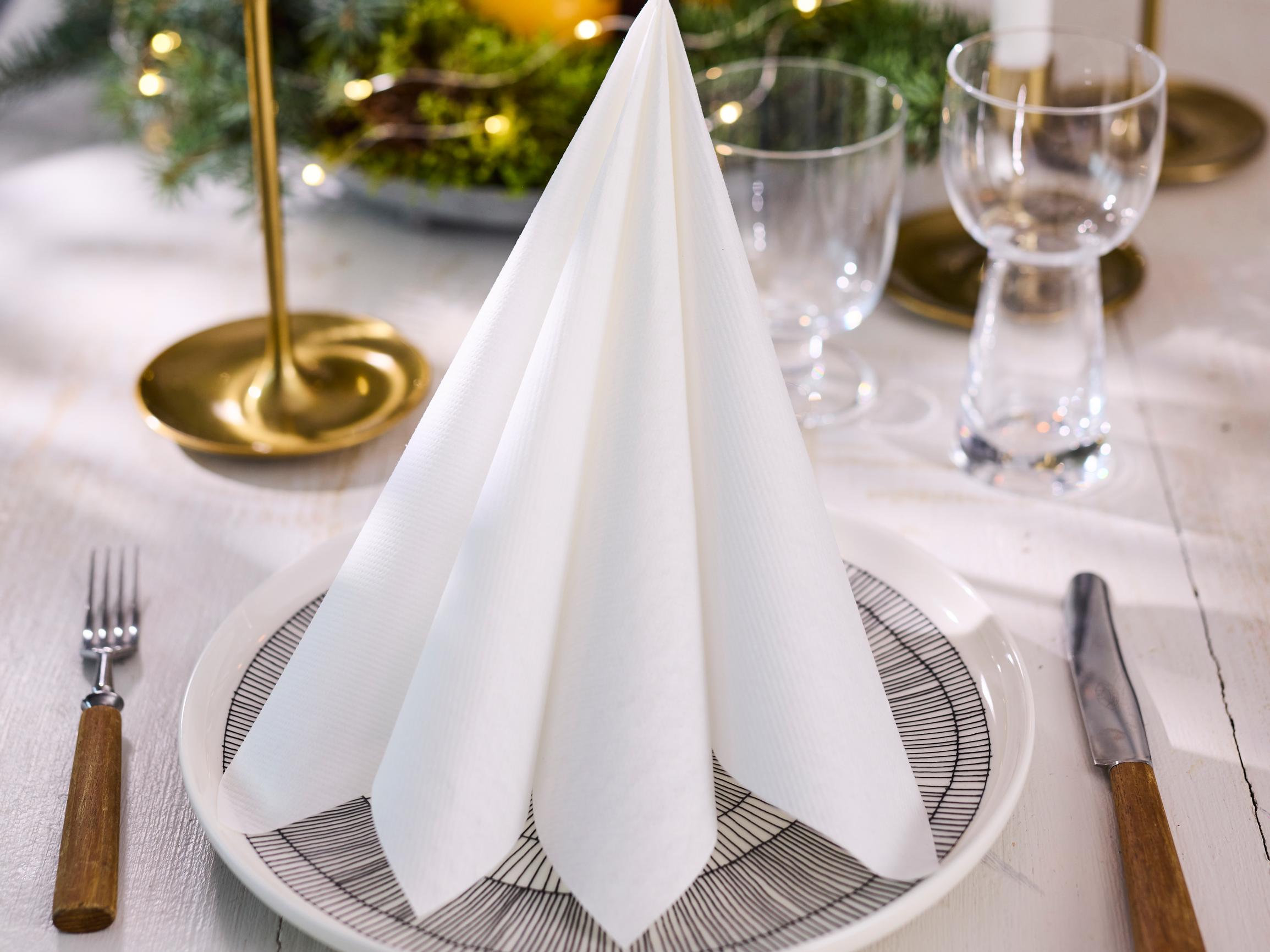 Fold a minimalist Christmas tree napkin—see the super-easy how-to