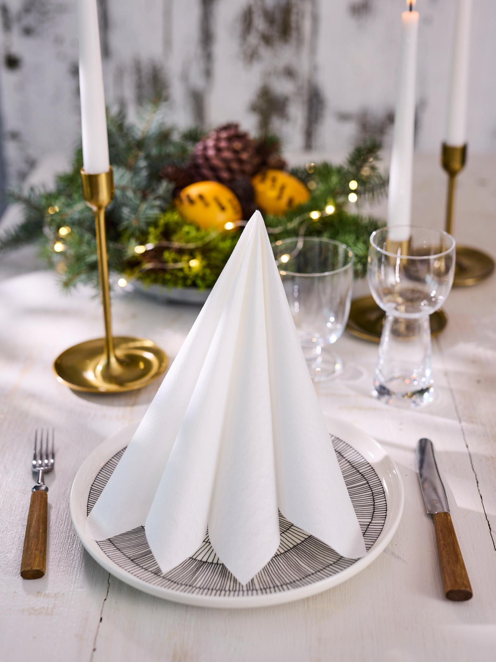 Fold a minimalist Christmas tree napkin—see the super-easy how-to