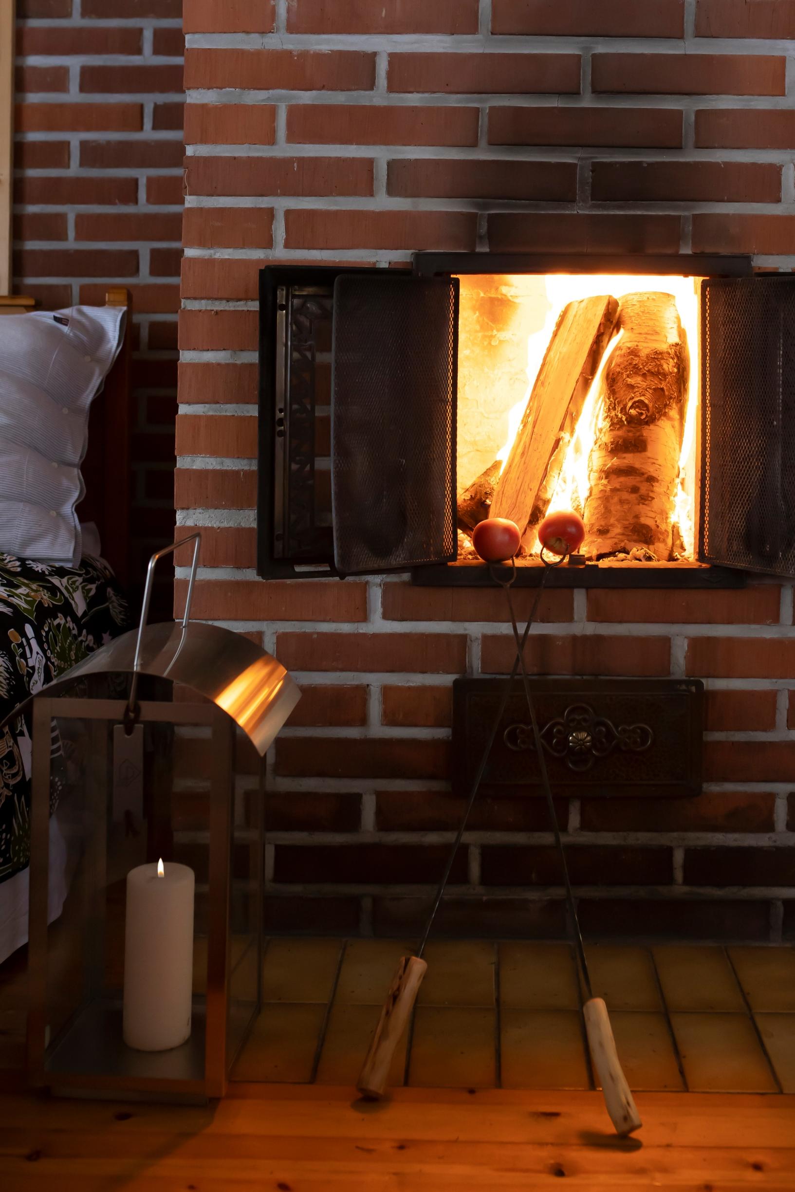 A fire burning in the masonry fireplace