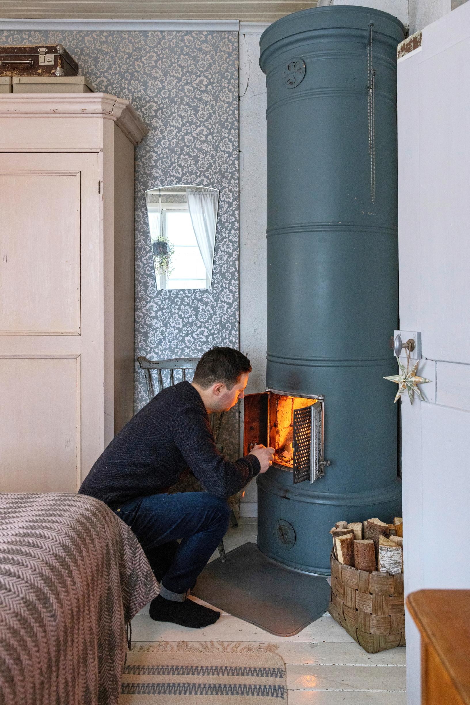 Jarkko Oja lighting the masonry stove
