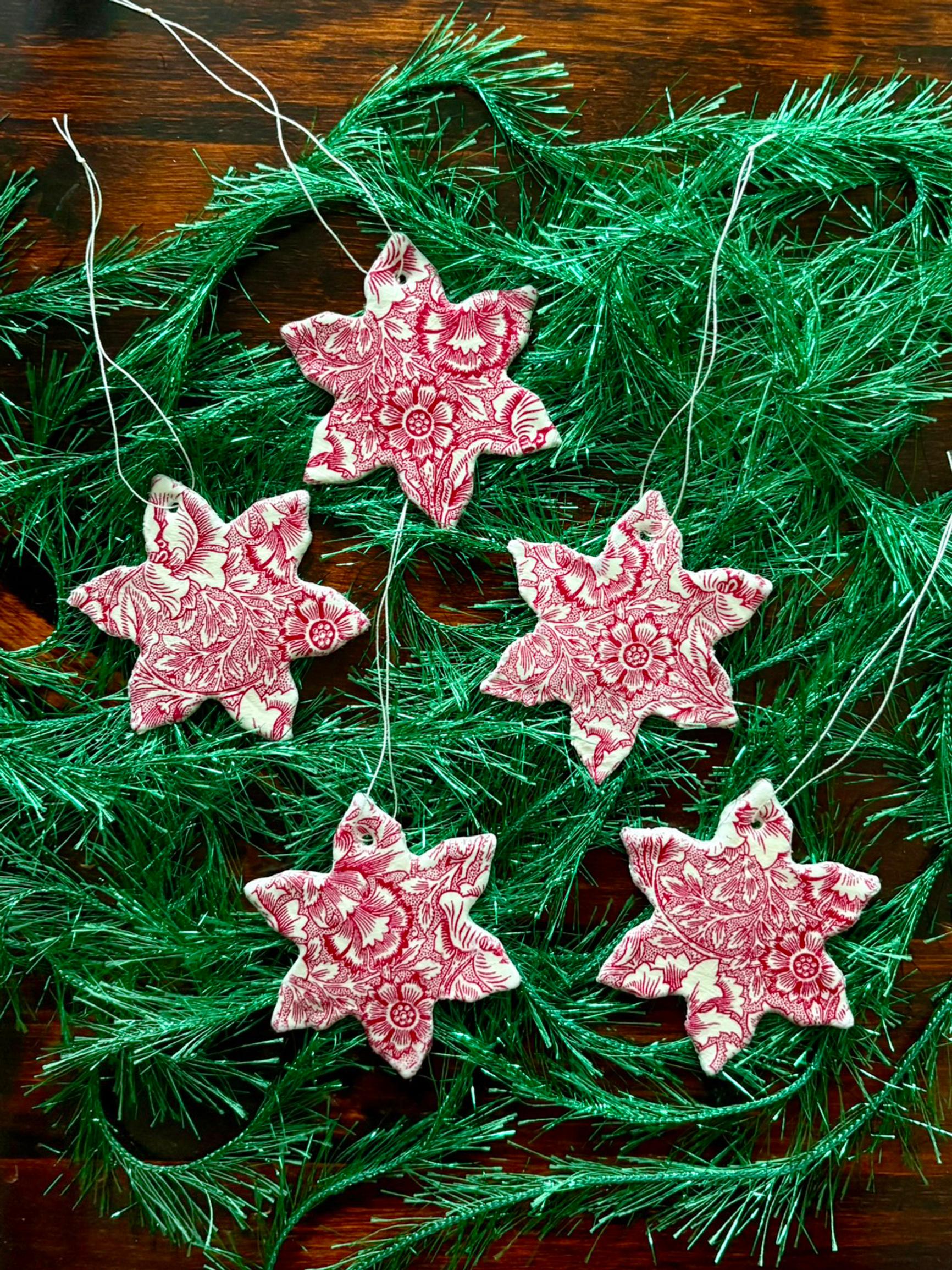 Make air-dry clay star ornaments—a napkin prints the pattern, a cookie cutter shapes them