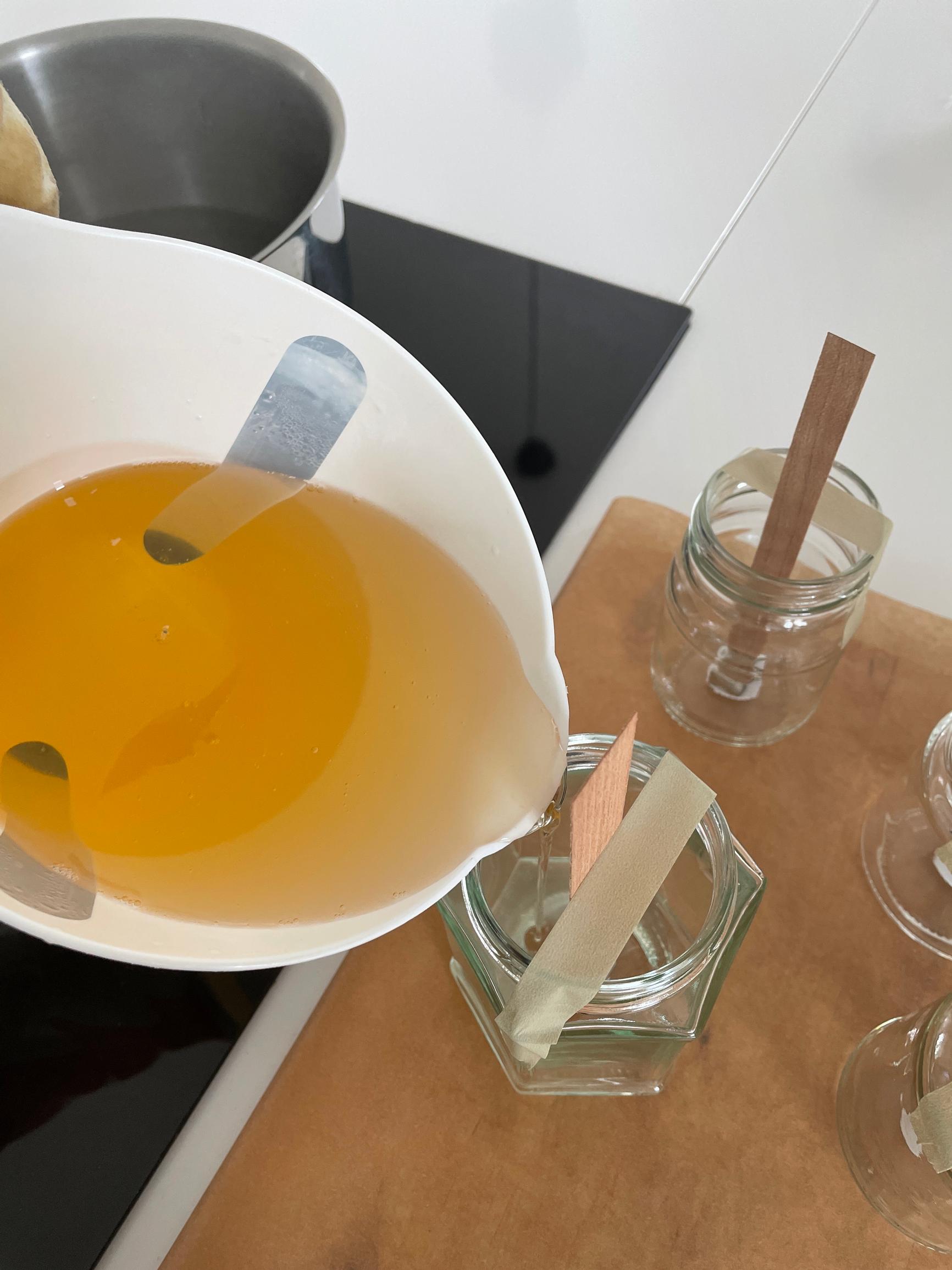 Pouring the melted wax into the container