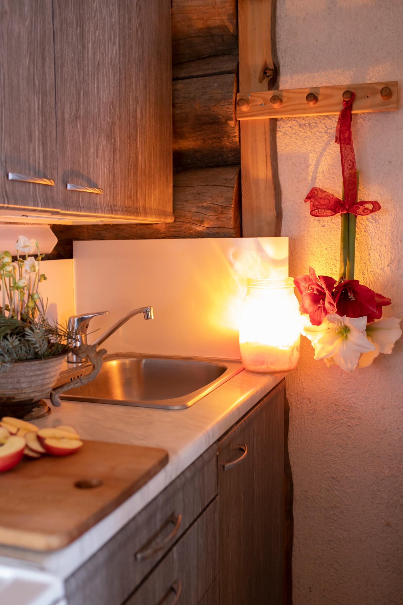 The cabin’s kitchen with an amaryllis flower hanging on the wall.