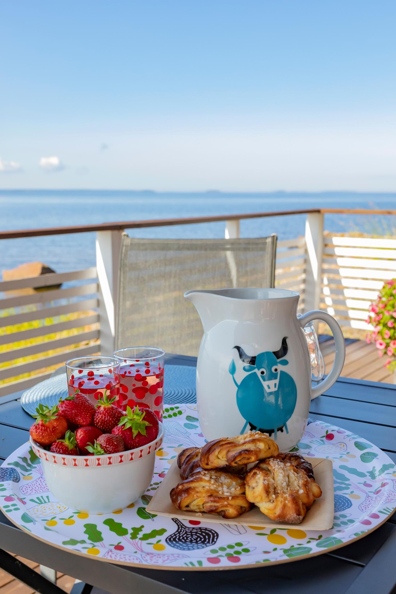 afternoon coffee served on a tray, with a sea view in the background