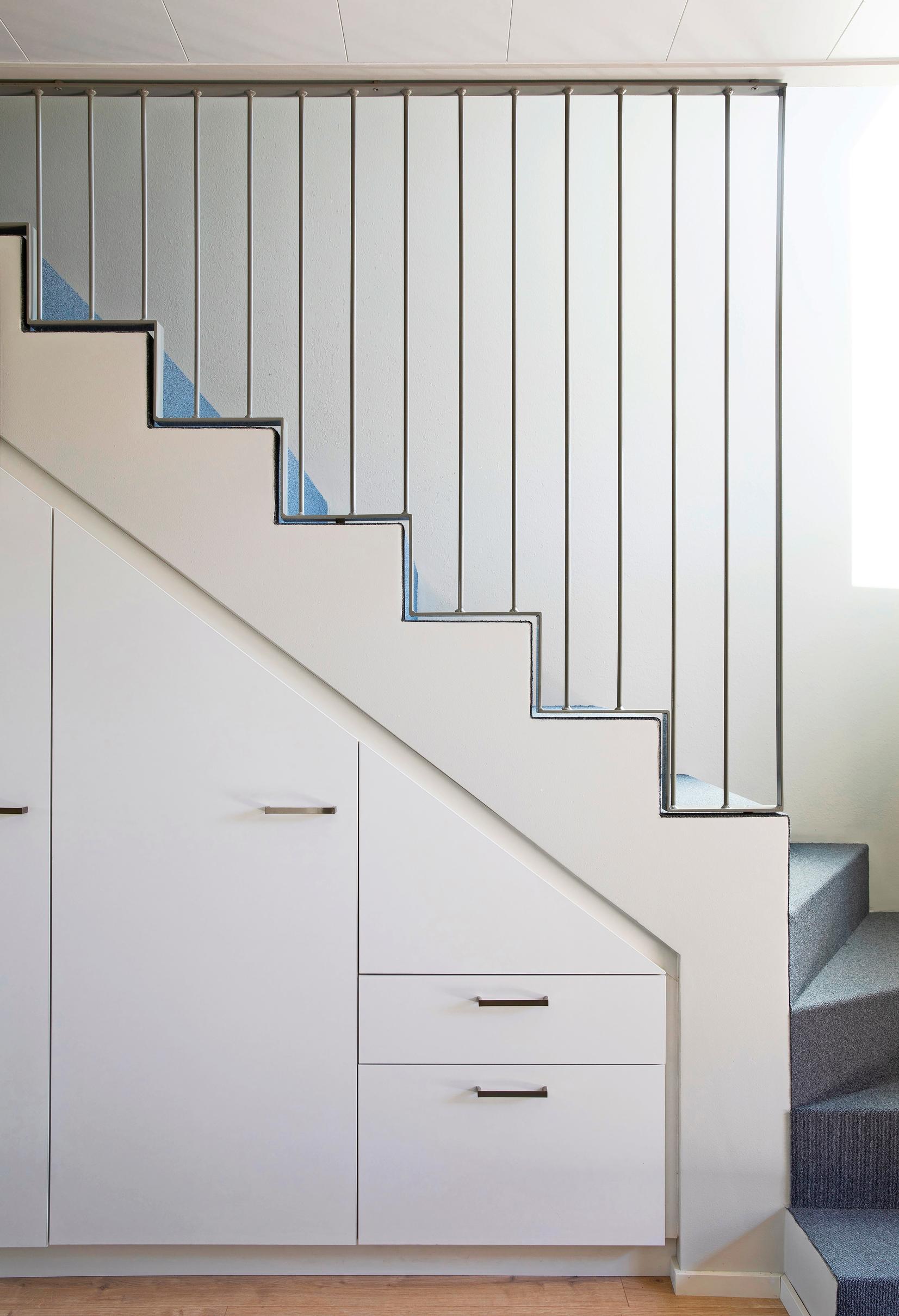 Cabinets and drawers integrated into the staircase