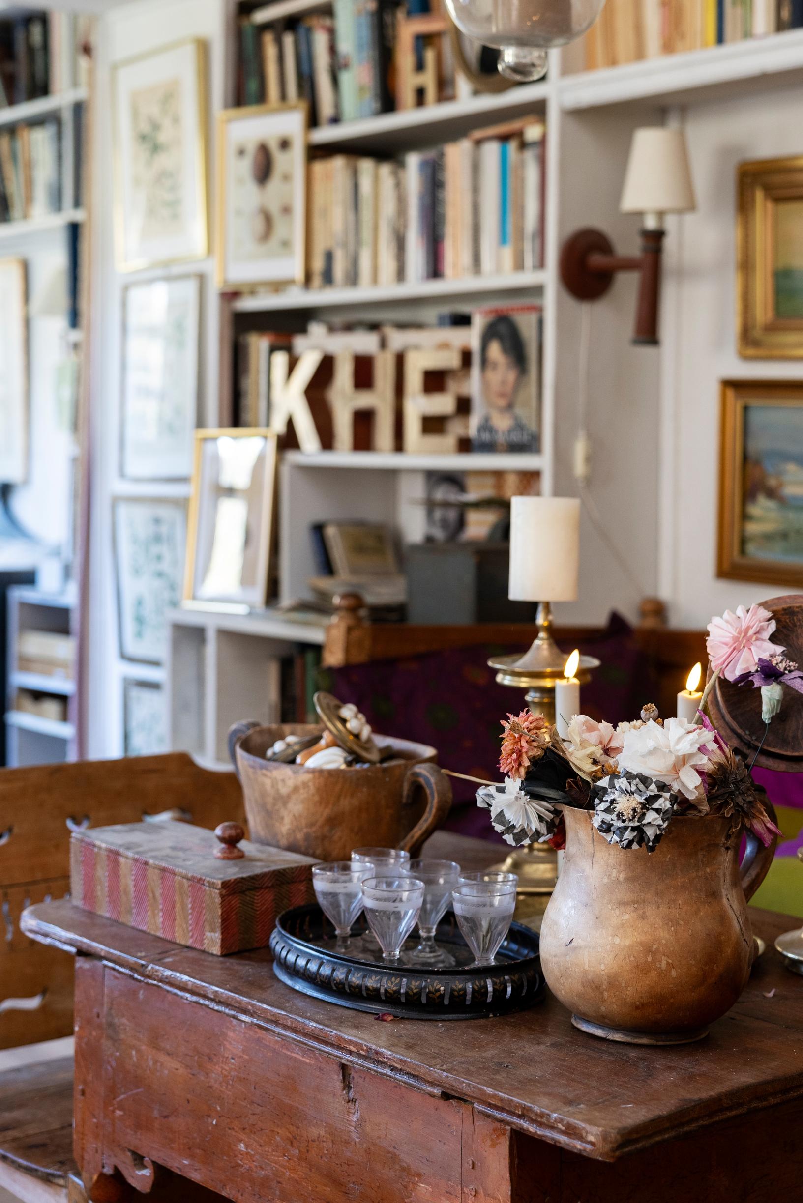 Vintage glassware, a tray, a pitcher, and a box on a table.