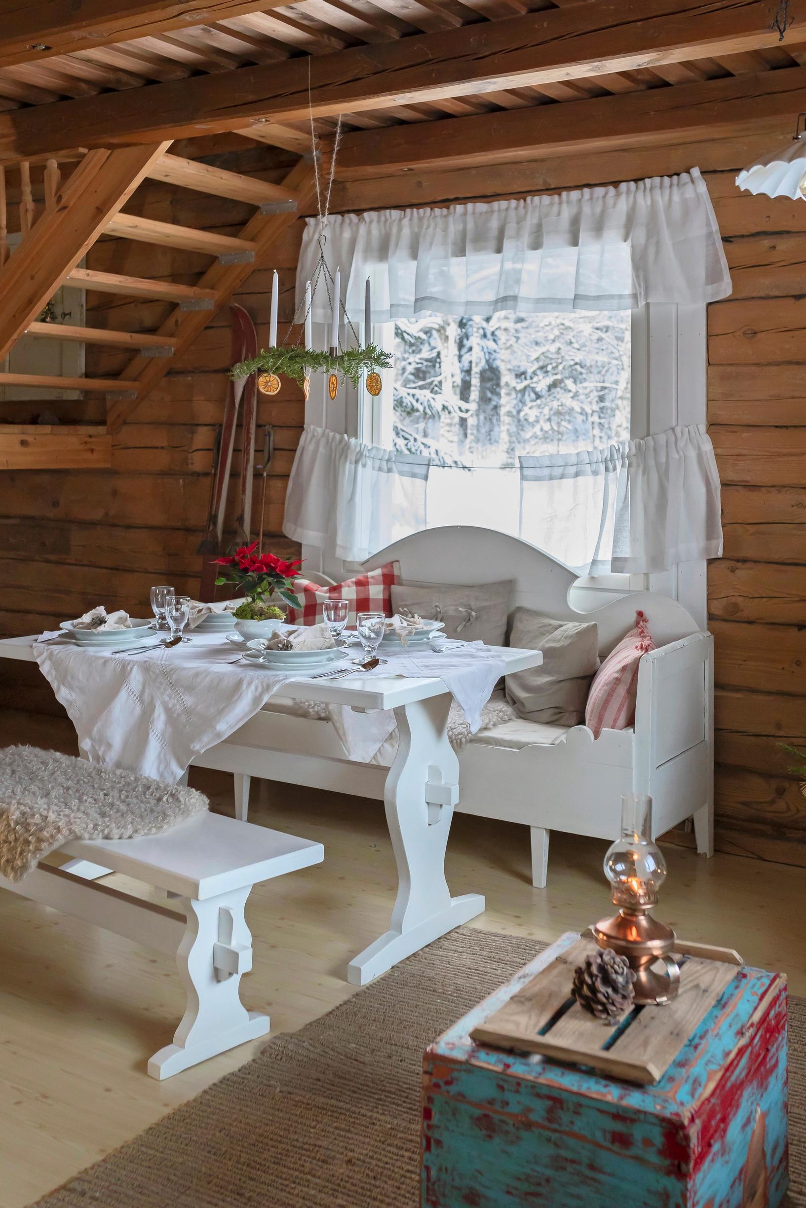 A wooden sofa in front of the window