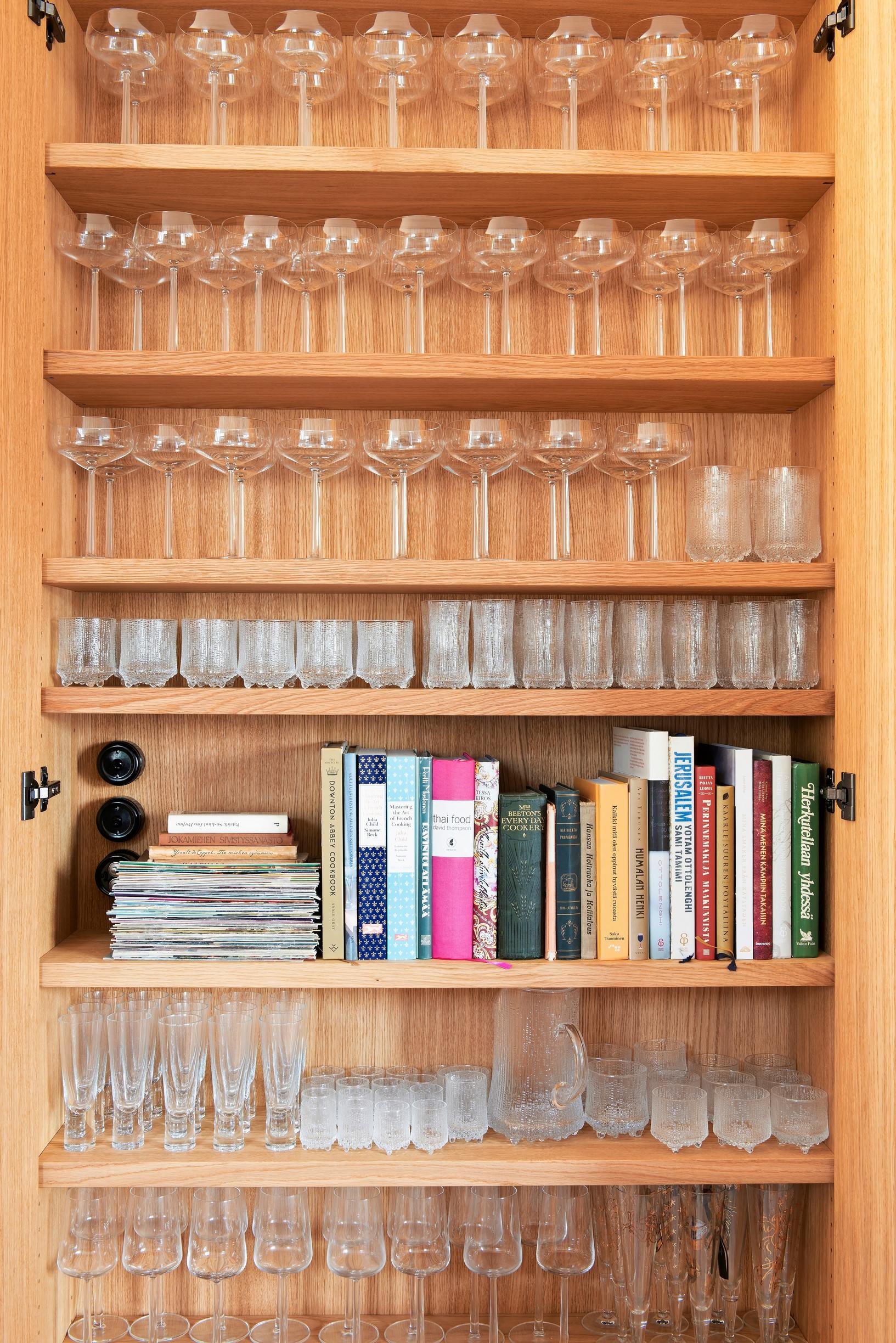 A cabinet holding an extensive Iittala glass collection.