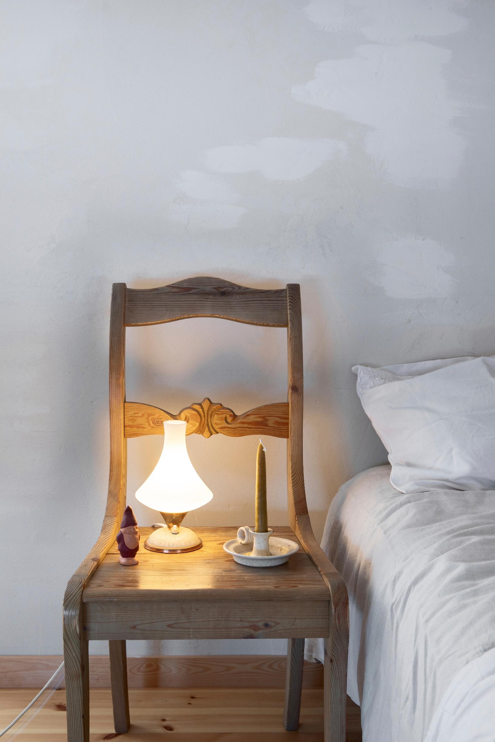 small lamp on a chair used as a nightstand