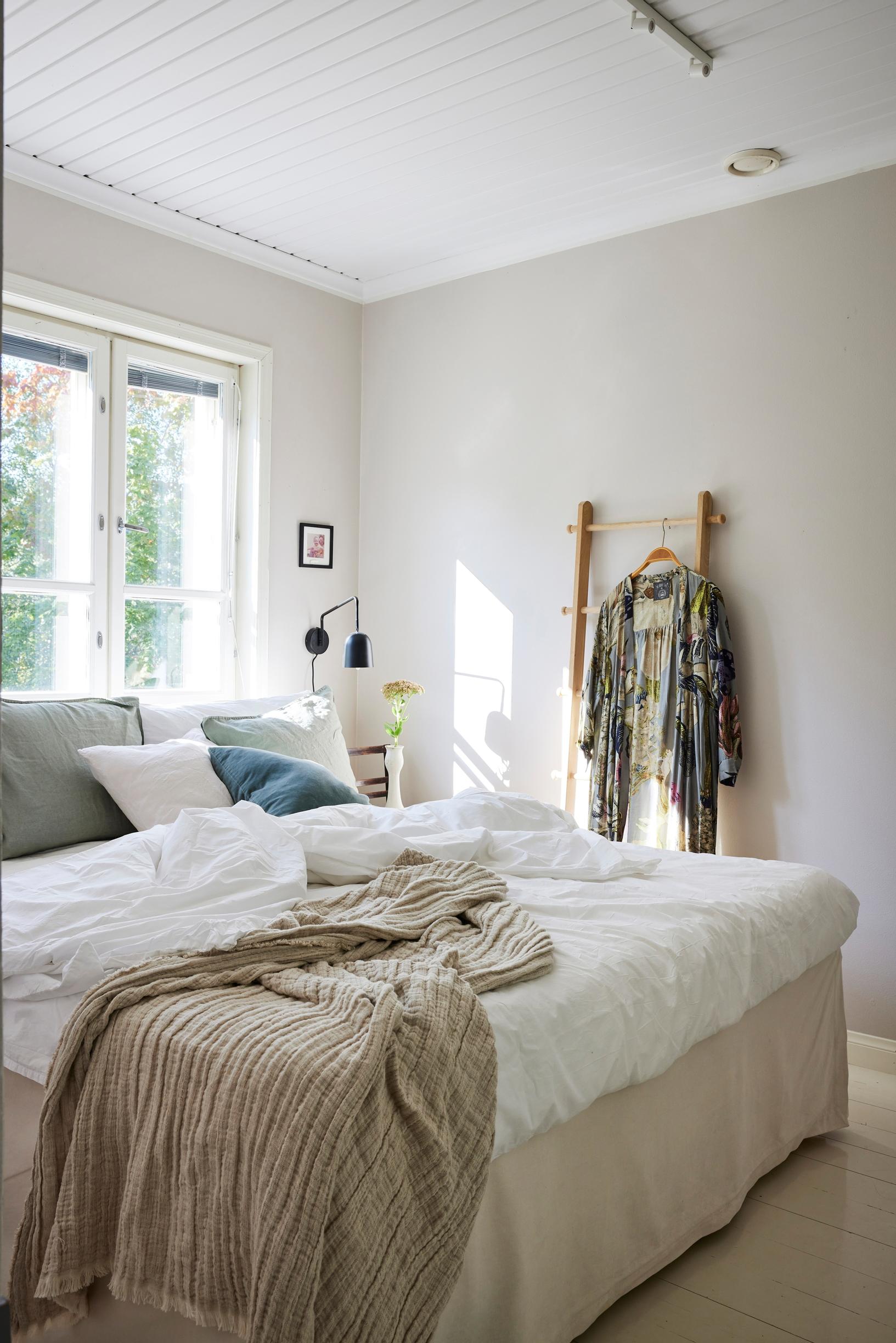 A bedroom with the bed under a window