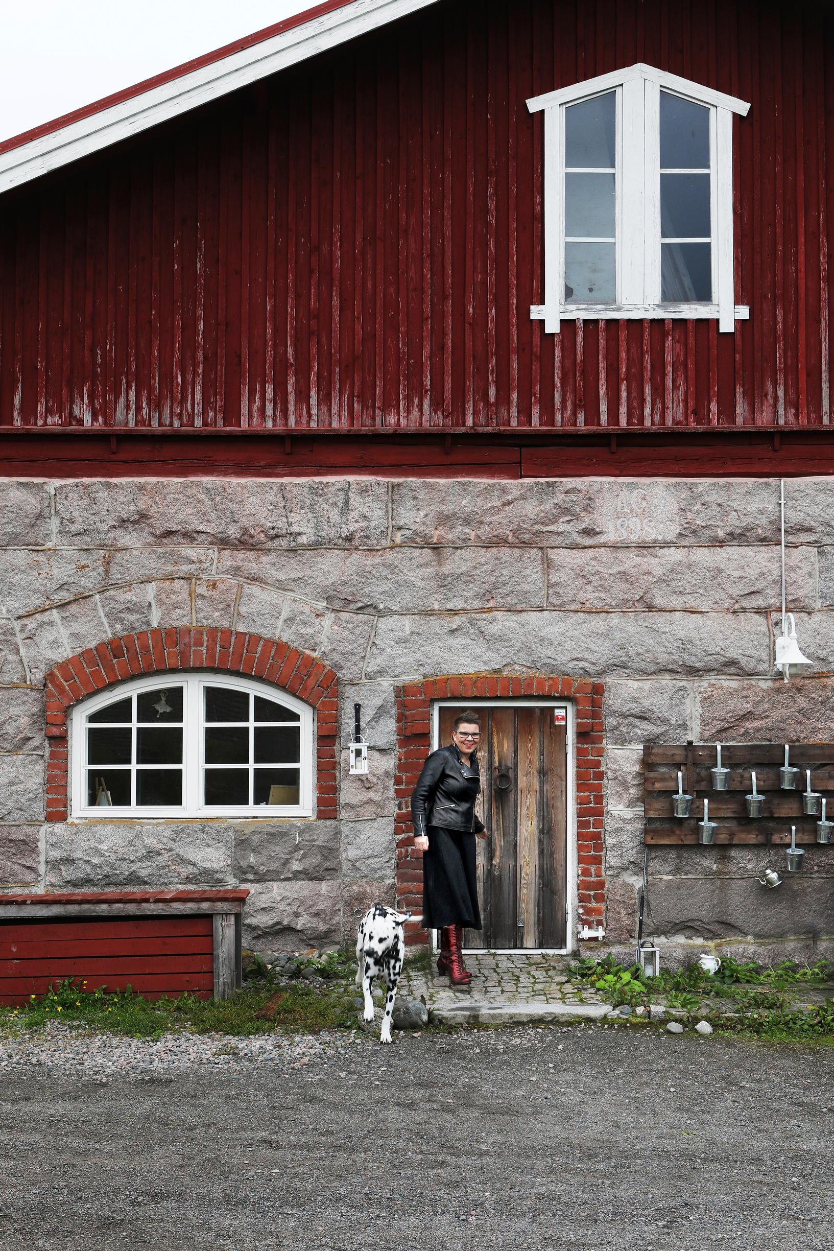 Maria Lassila-Merisalo standing at the door of her home
