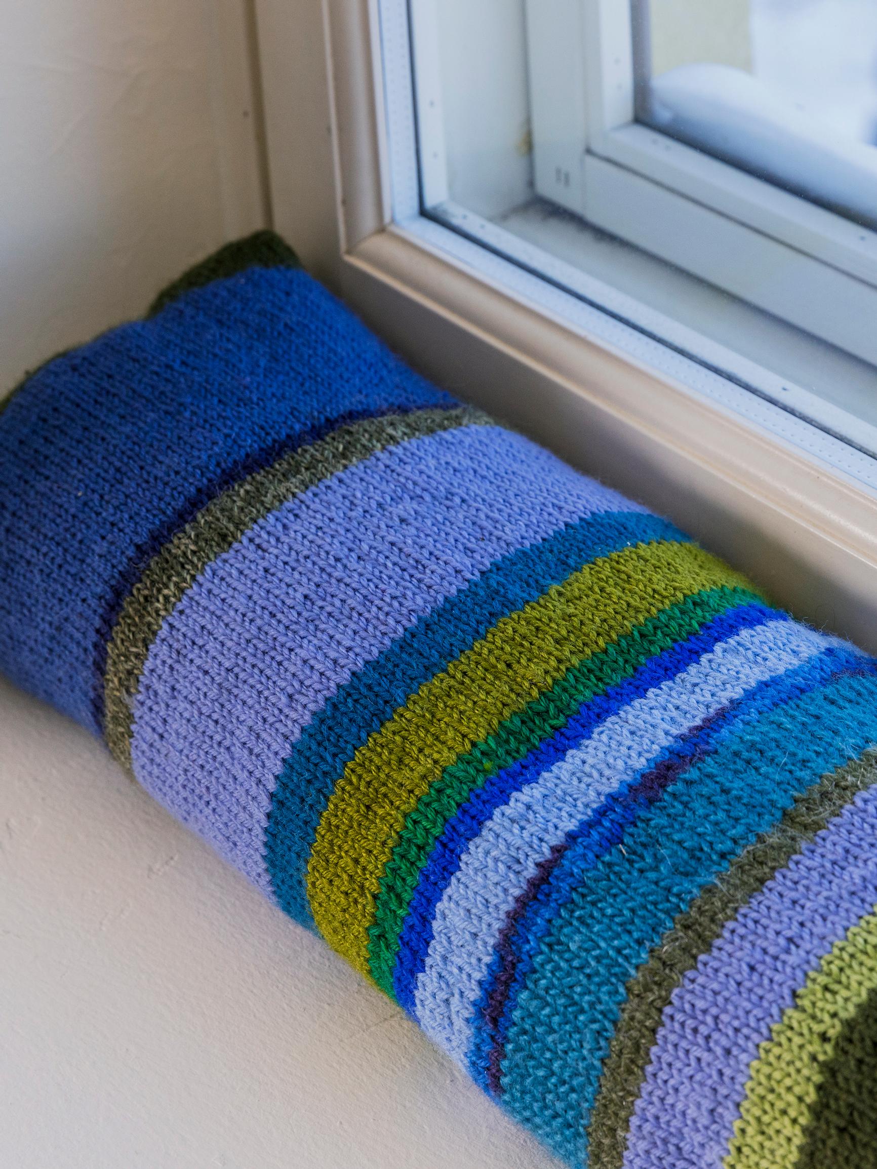 Defeat drafts with a fun draft stopper—easy to knit from scrap yarn