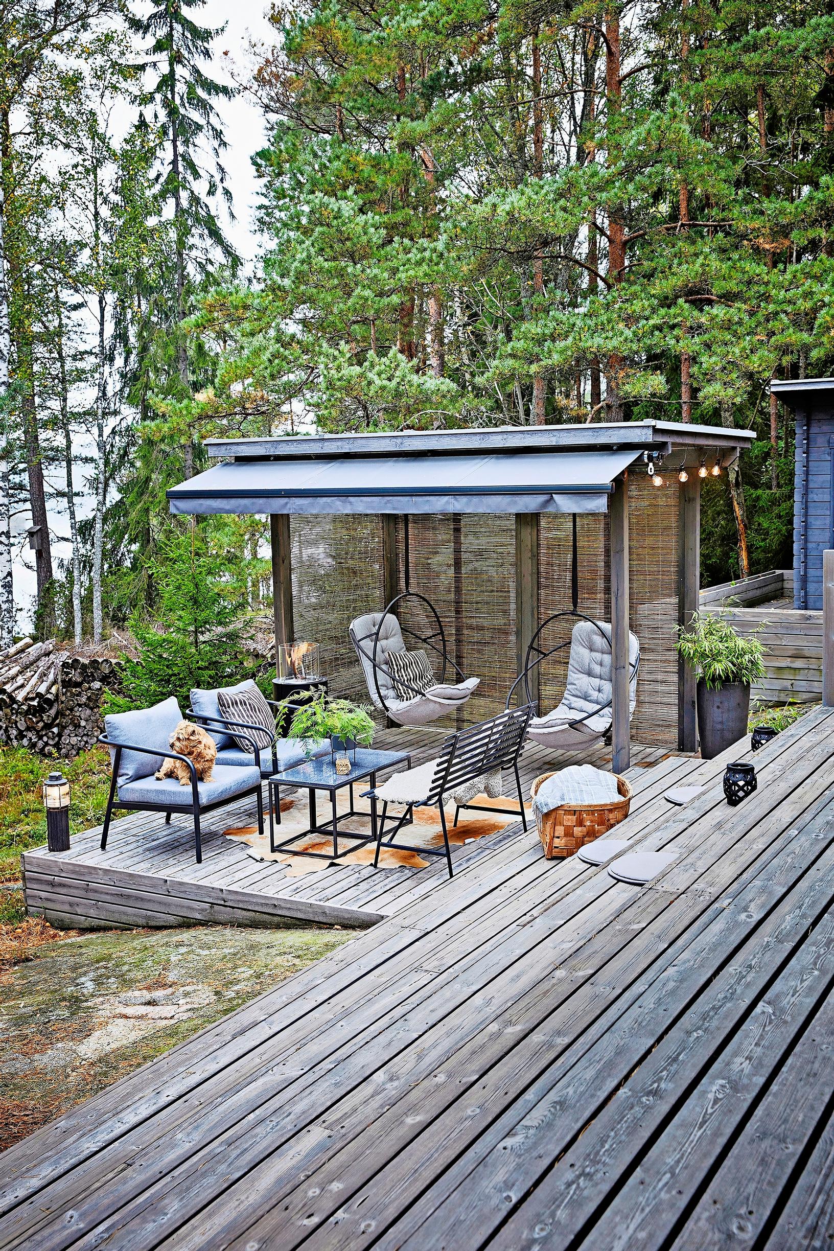 An awning canopy shelters a delicate patio sofa set.