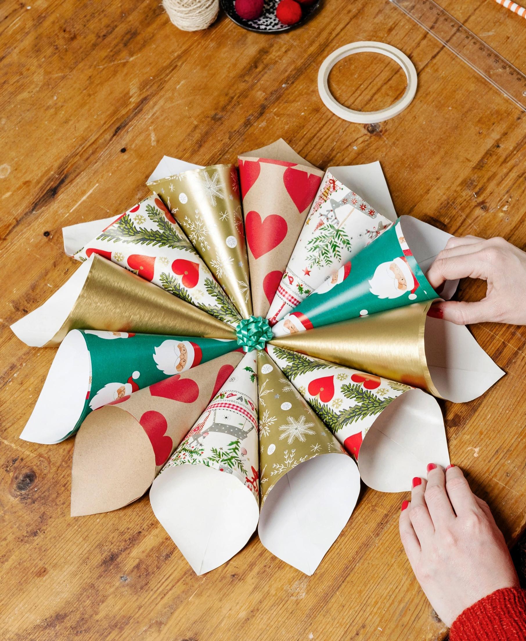 Decorating the finished cone star with a small bow