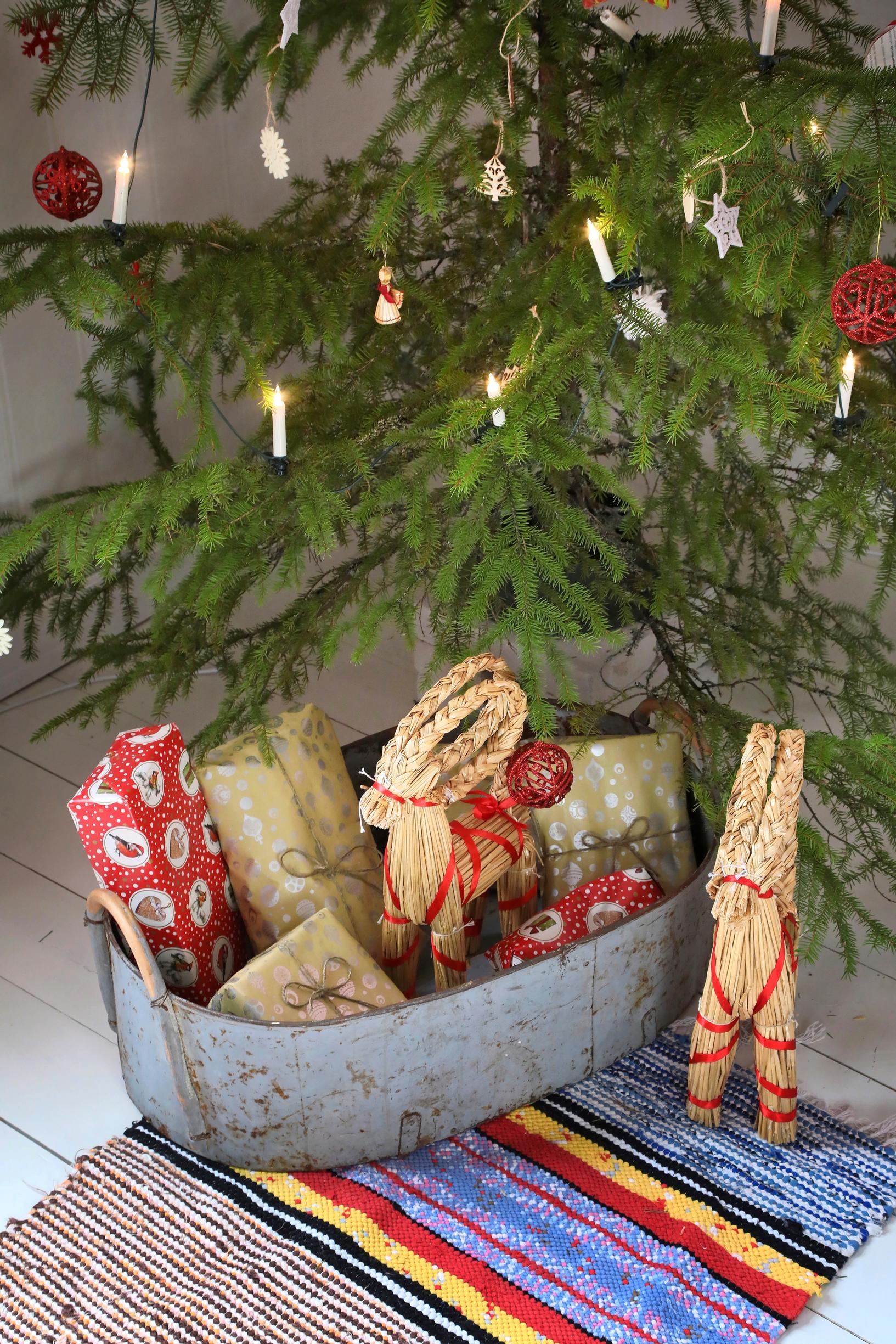 Christmas presents in a zinc grain bin under the tree