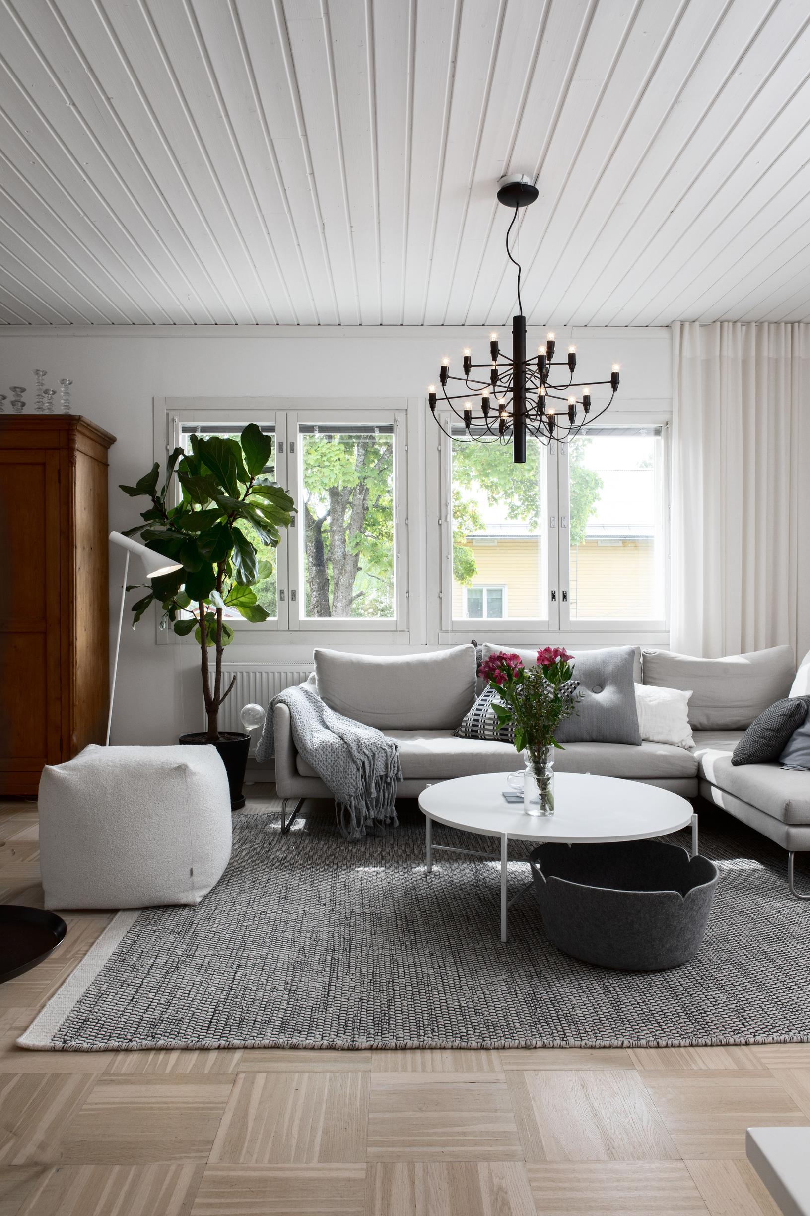 Living room with a light-colored sofa in front of the window.