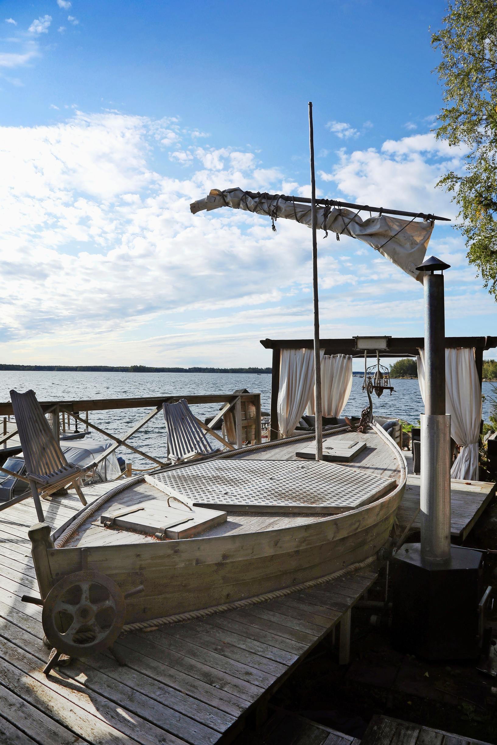 An old sailboat on the dock, hiding the hot tub.