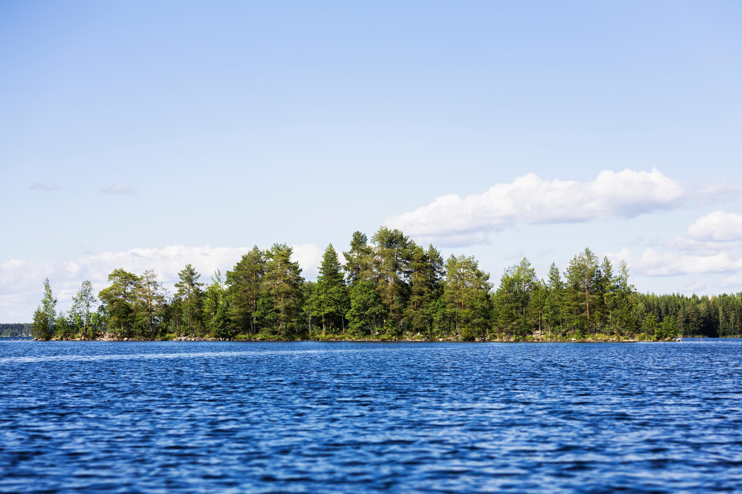 Vividly blue lake with trees on an island in the background
