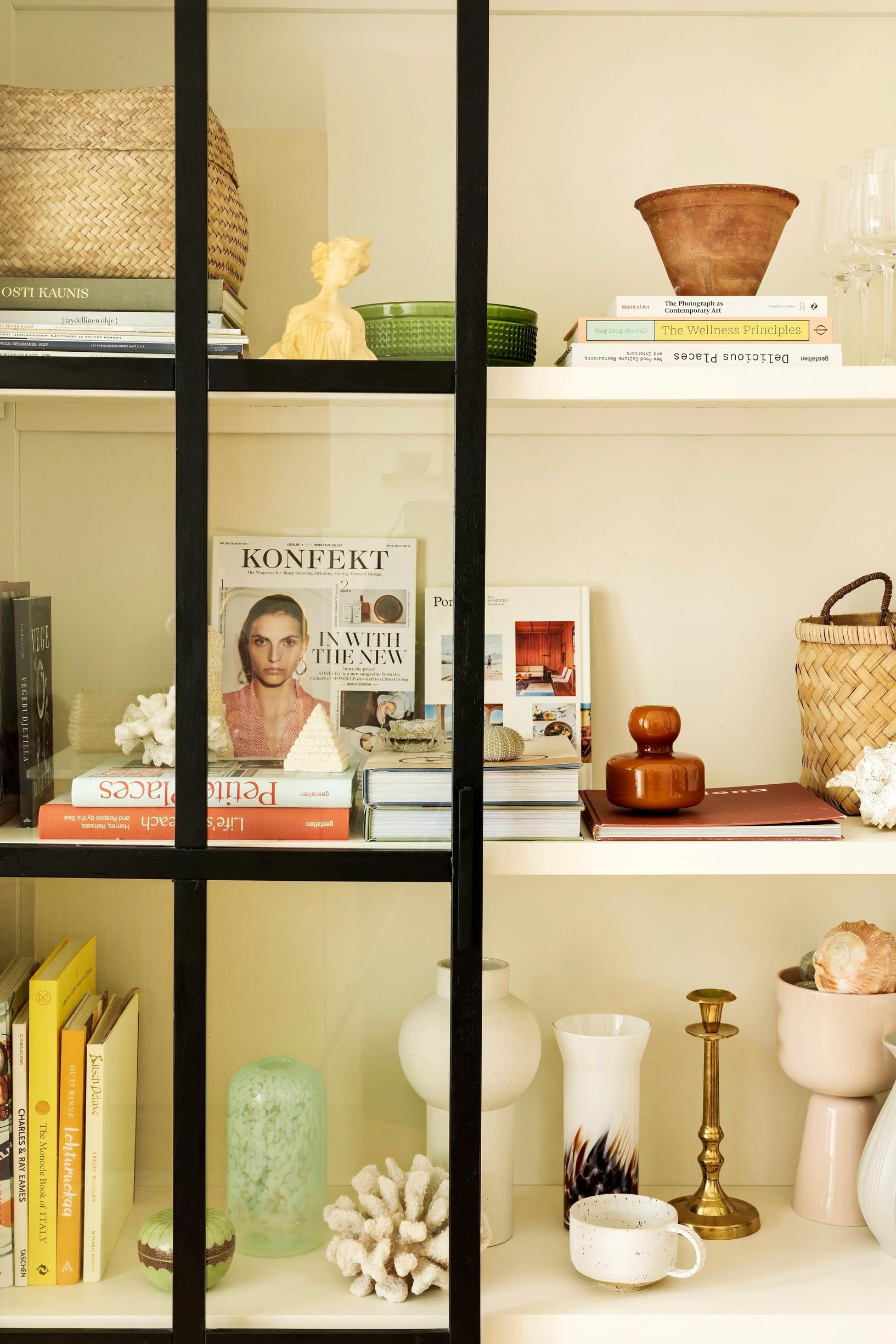 Bloomingville’s black cabinet with design pieces and magazines inside.