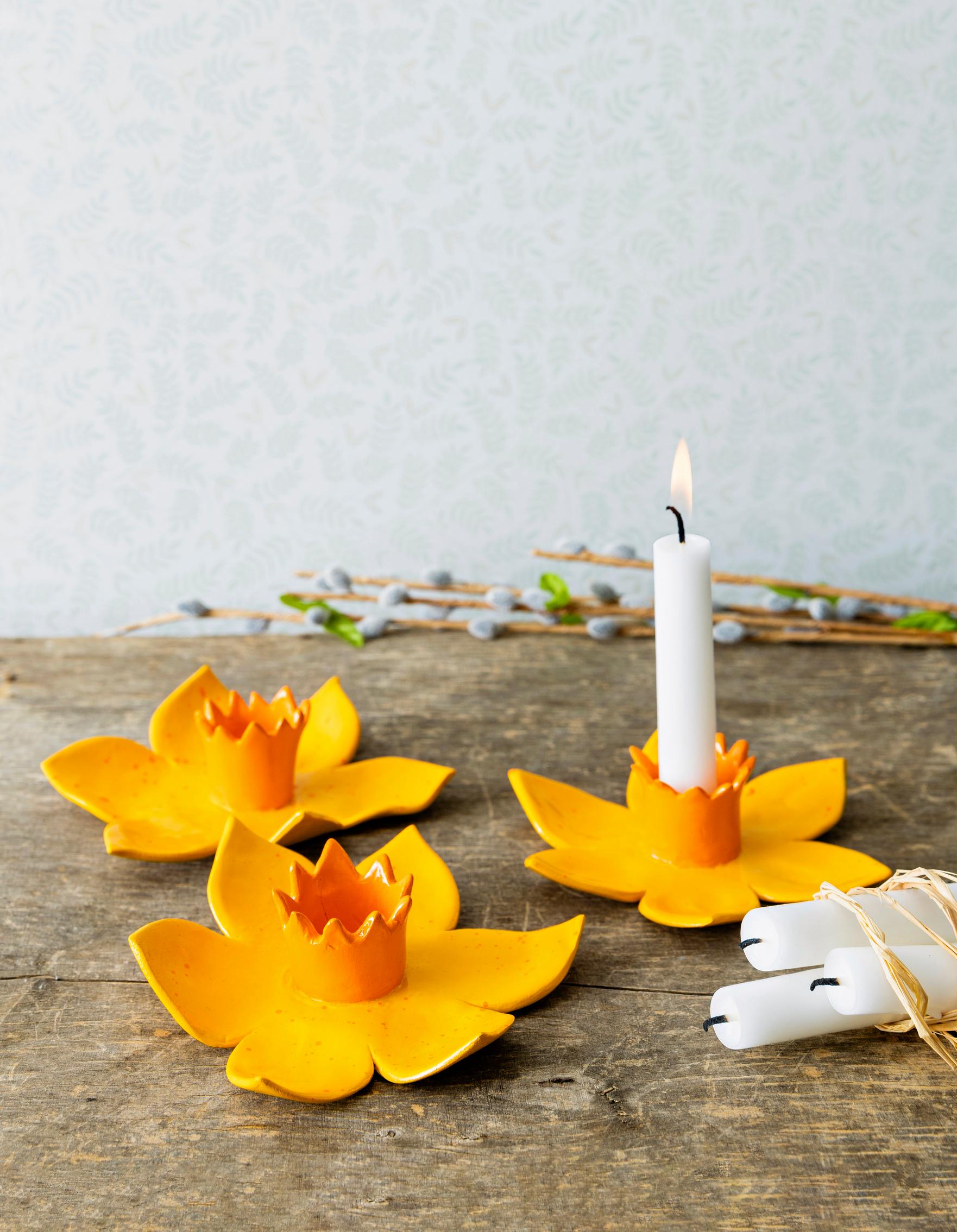 Finished daffodil candle holders on a table