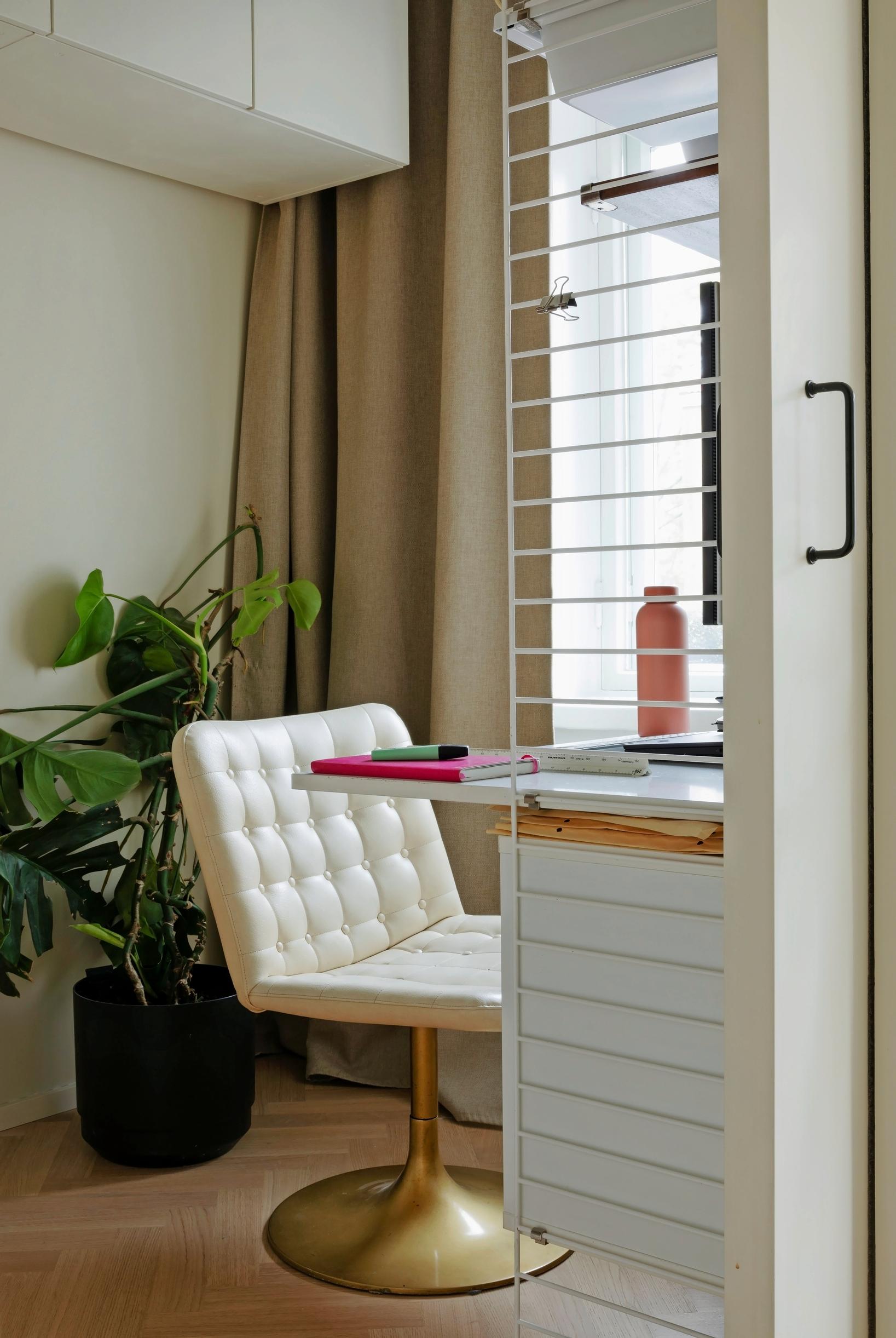 In the office, a sliding door, a String desk, and a 1970s chair