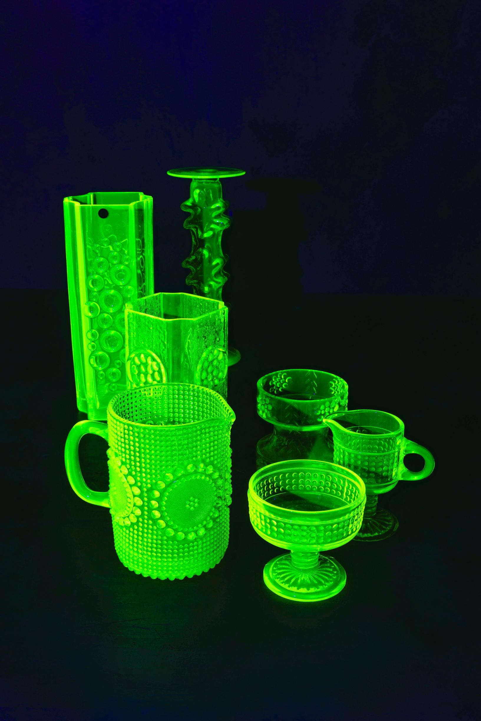 Uranium glass items glowing under UV light