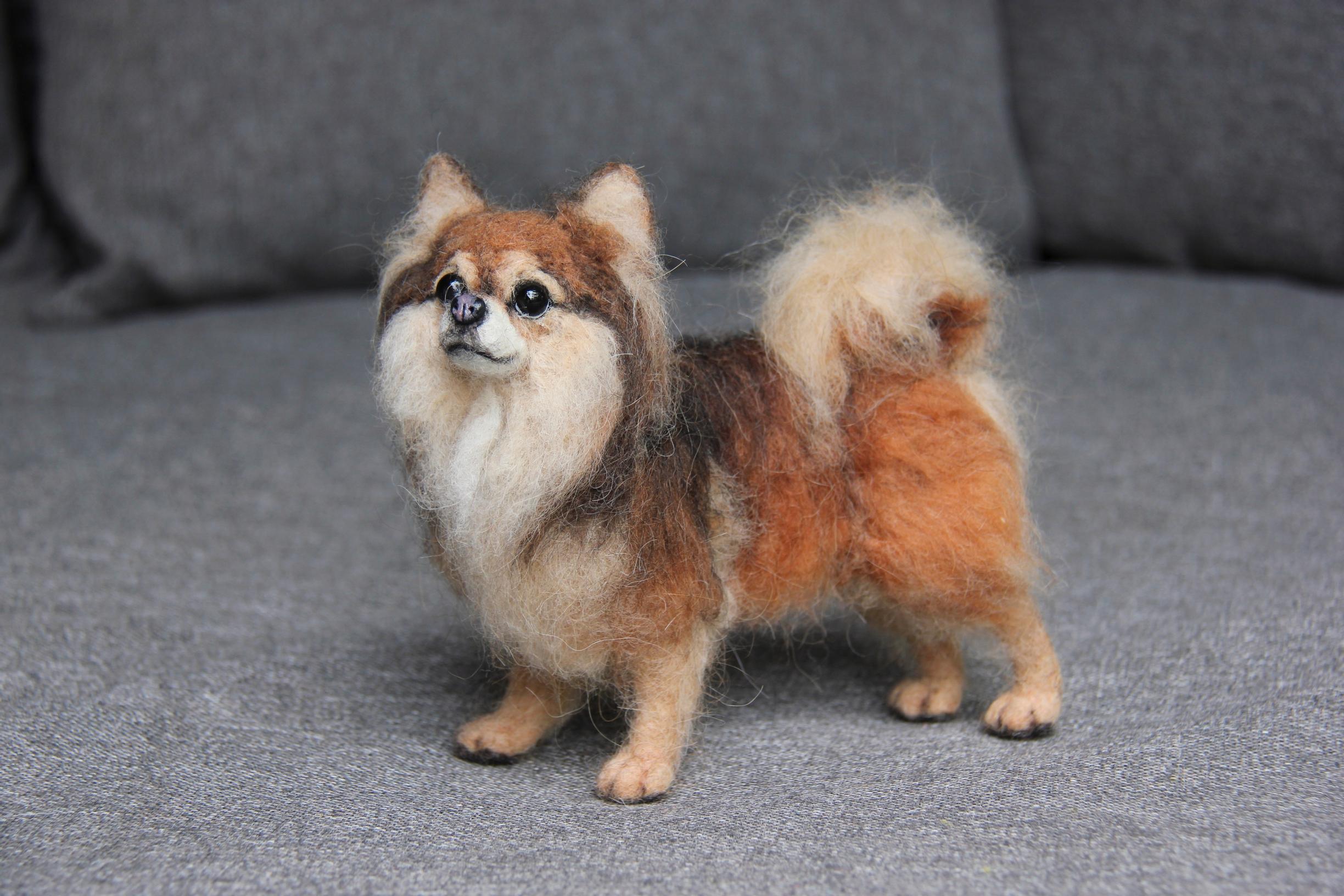 A miniature felted dog