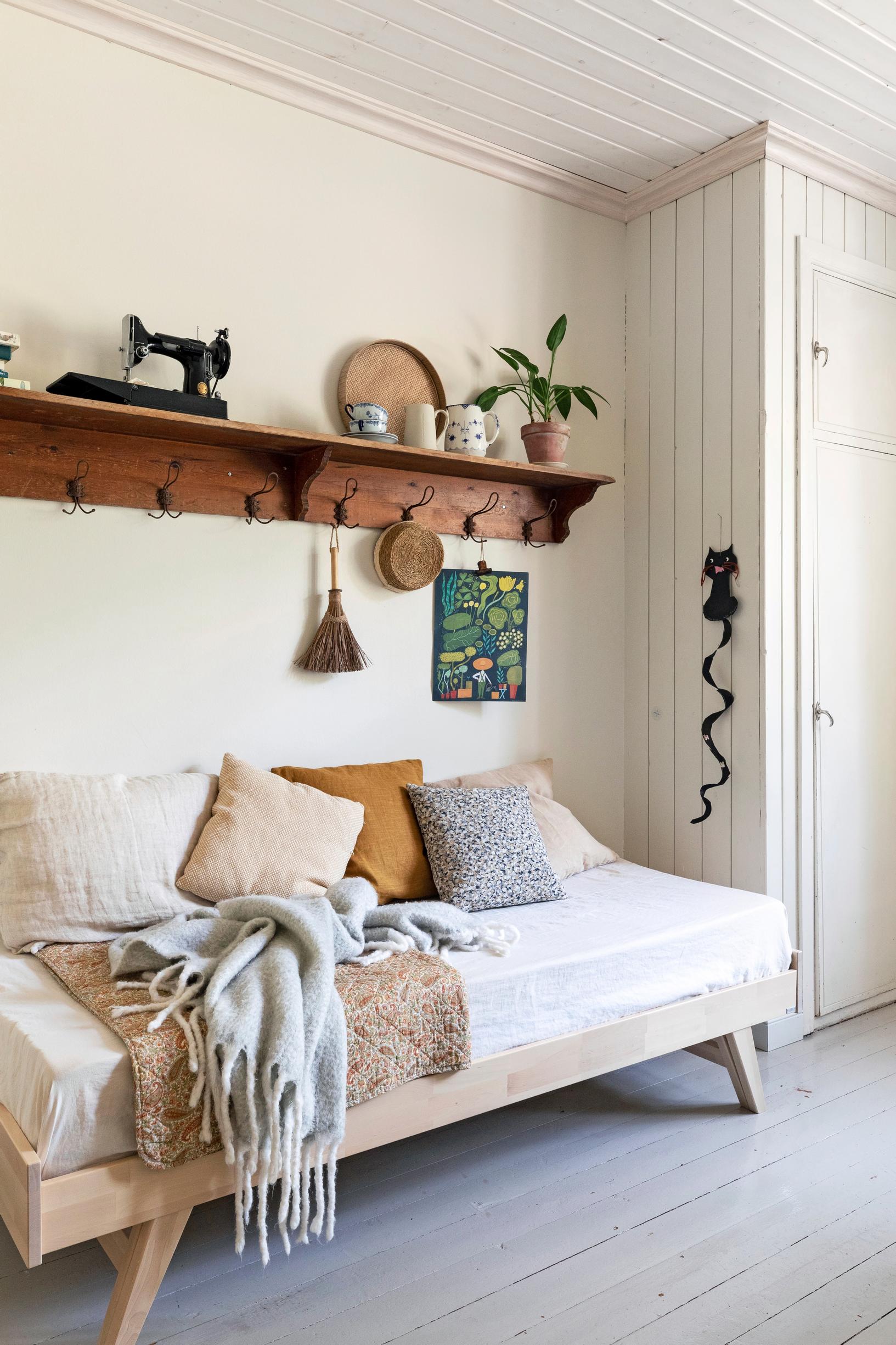 An old coat rack and a sleeper sofa