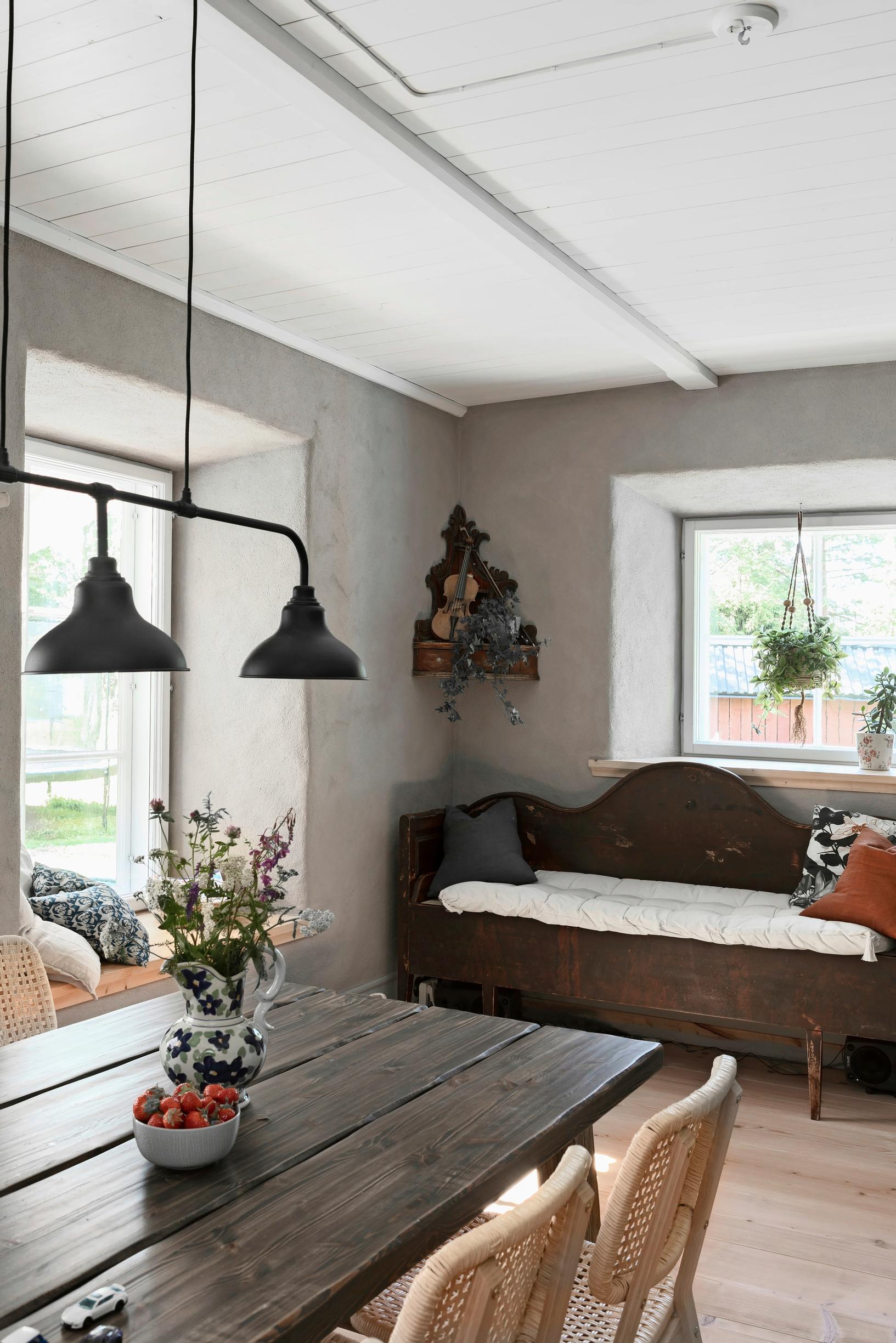 A wooden bench in front of a window