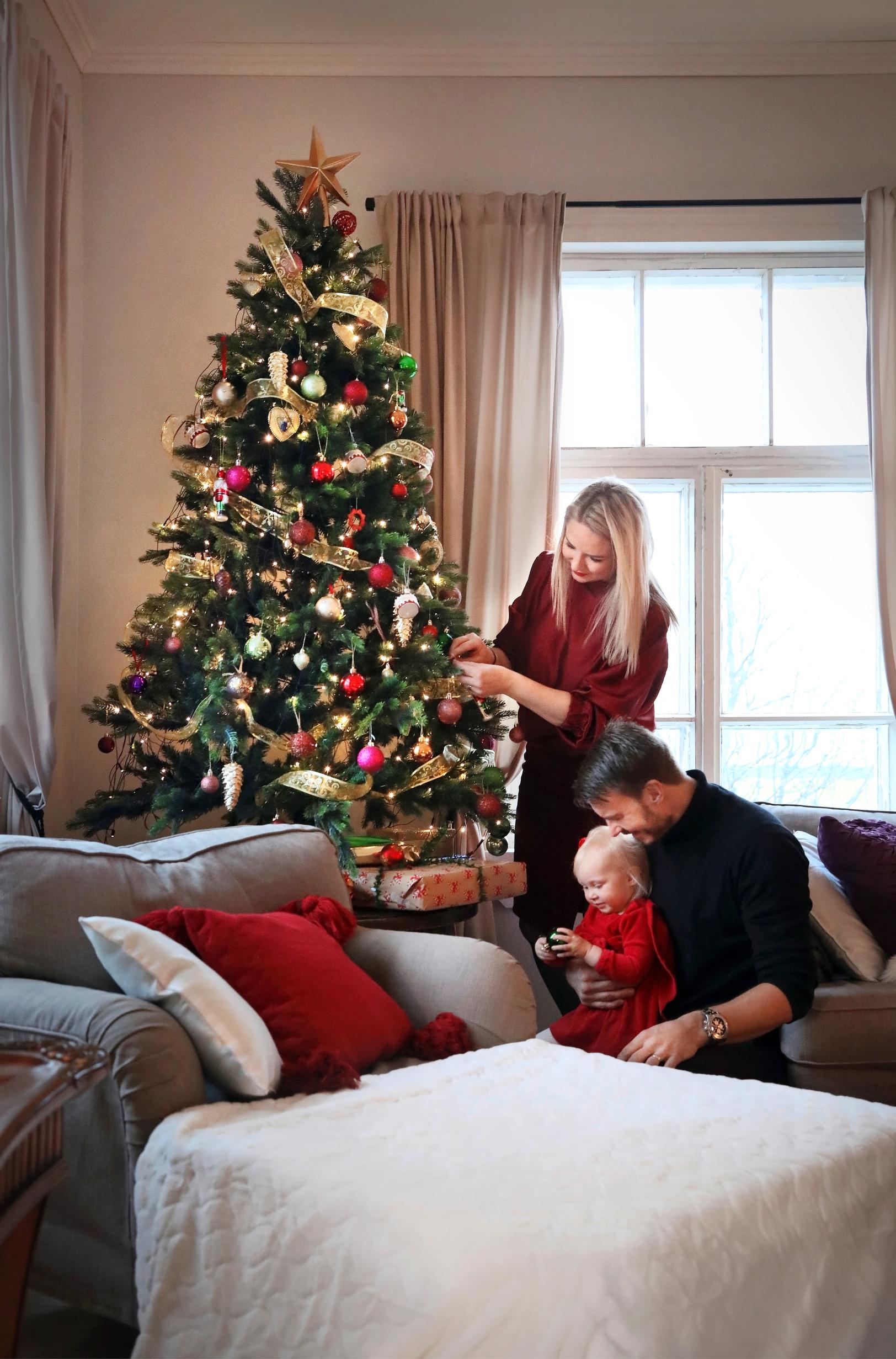 The Rekola family decorating a lavish American-style Christmas tree