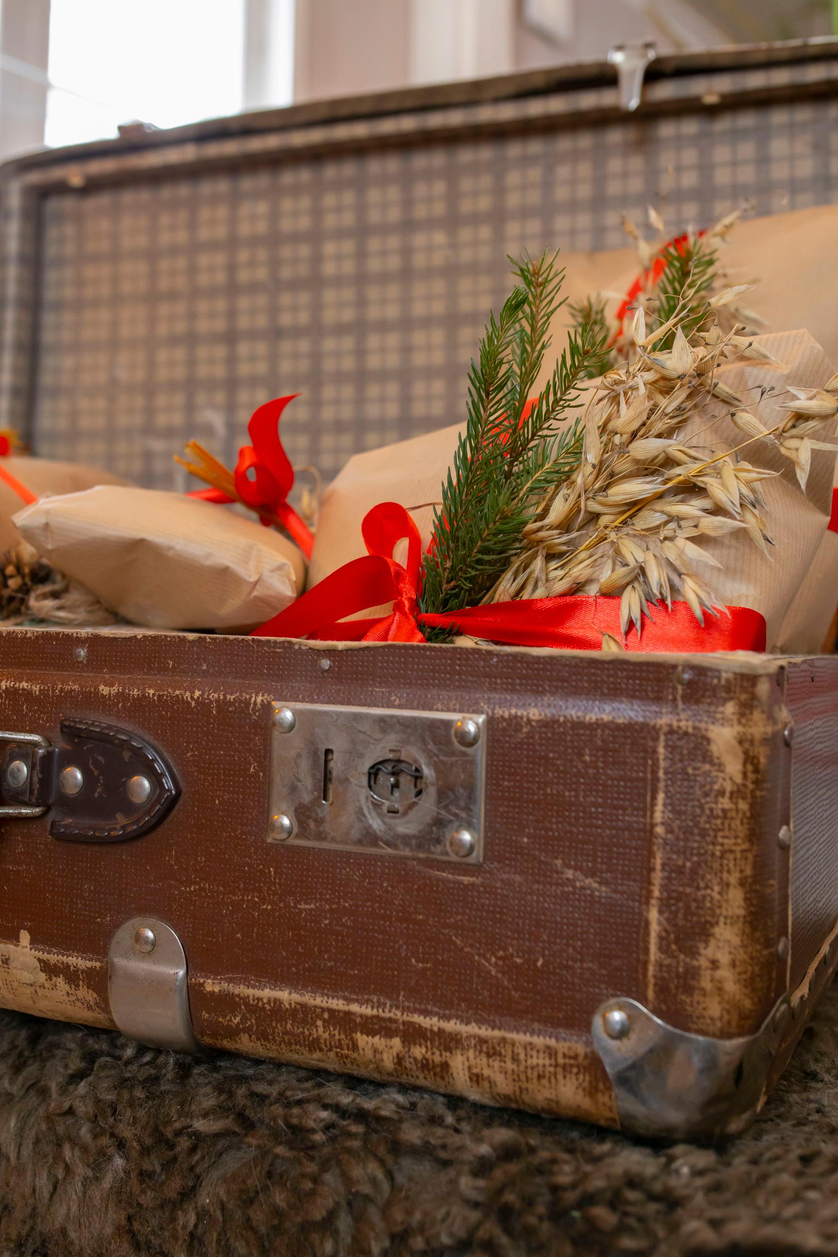 An old suitcase filled with Christmas ornaments.