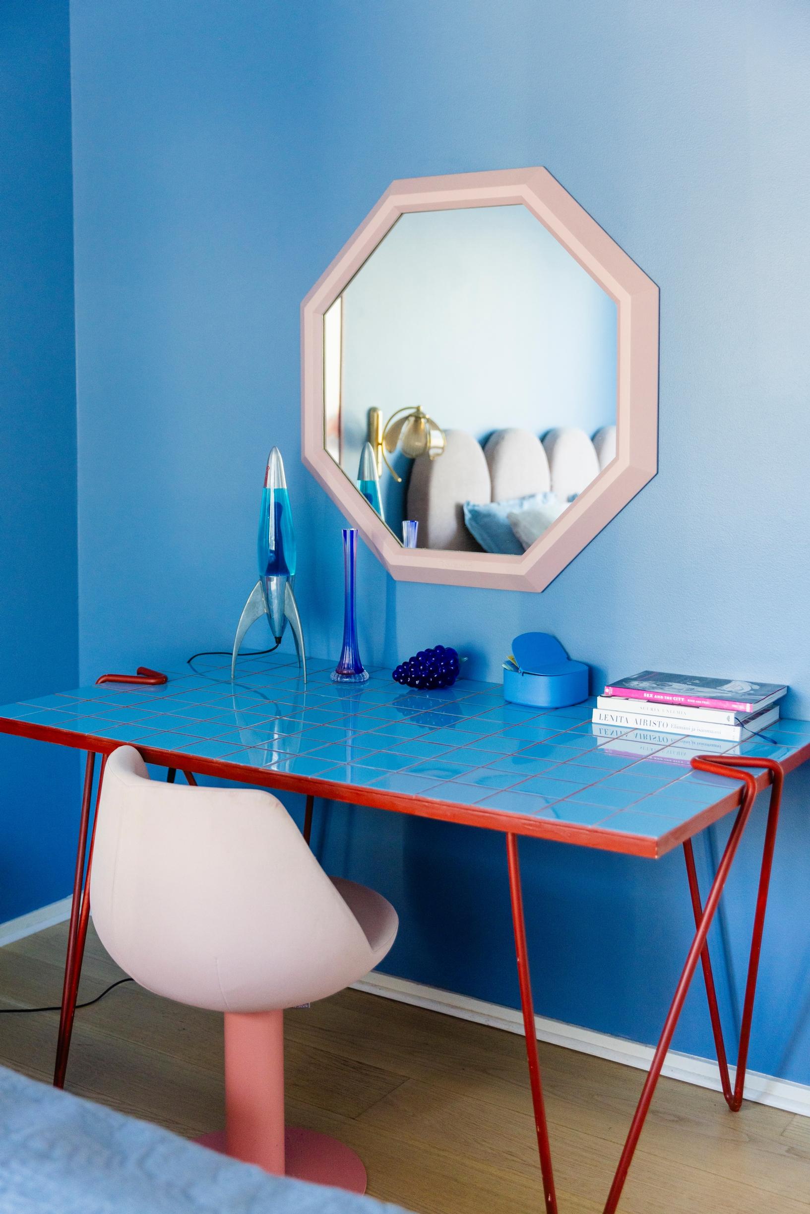 a blue tiled table and a blue-painted wall