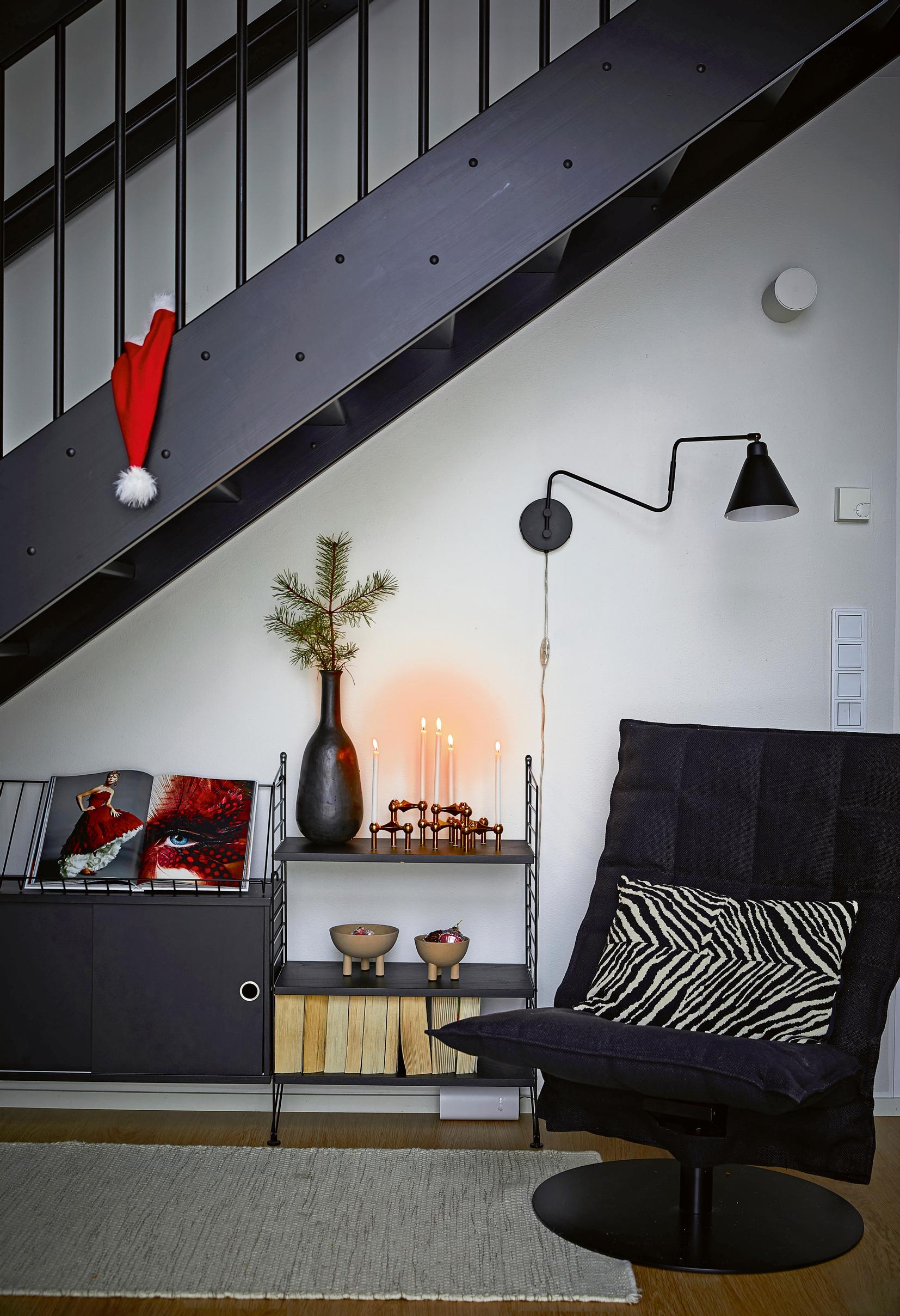 black armchair and shelving under the staircase