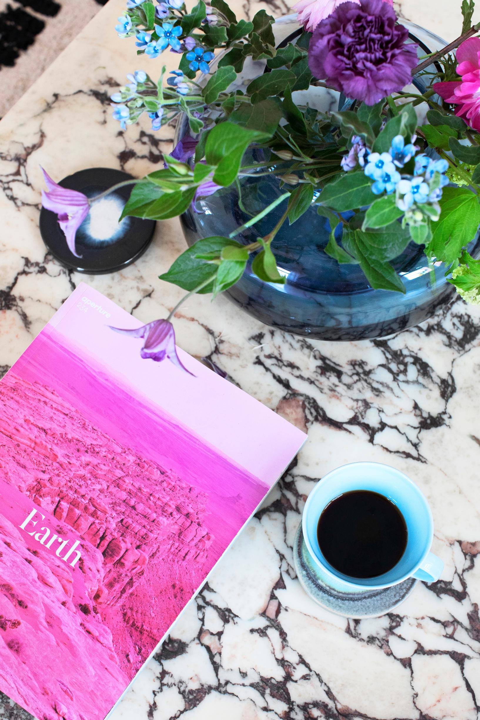 A marble-topped coffee table and flowers
