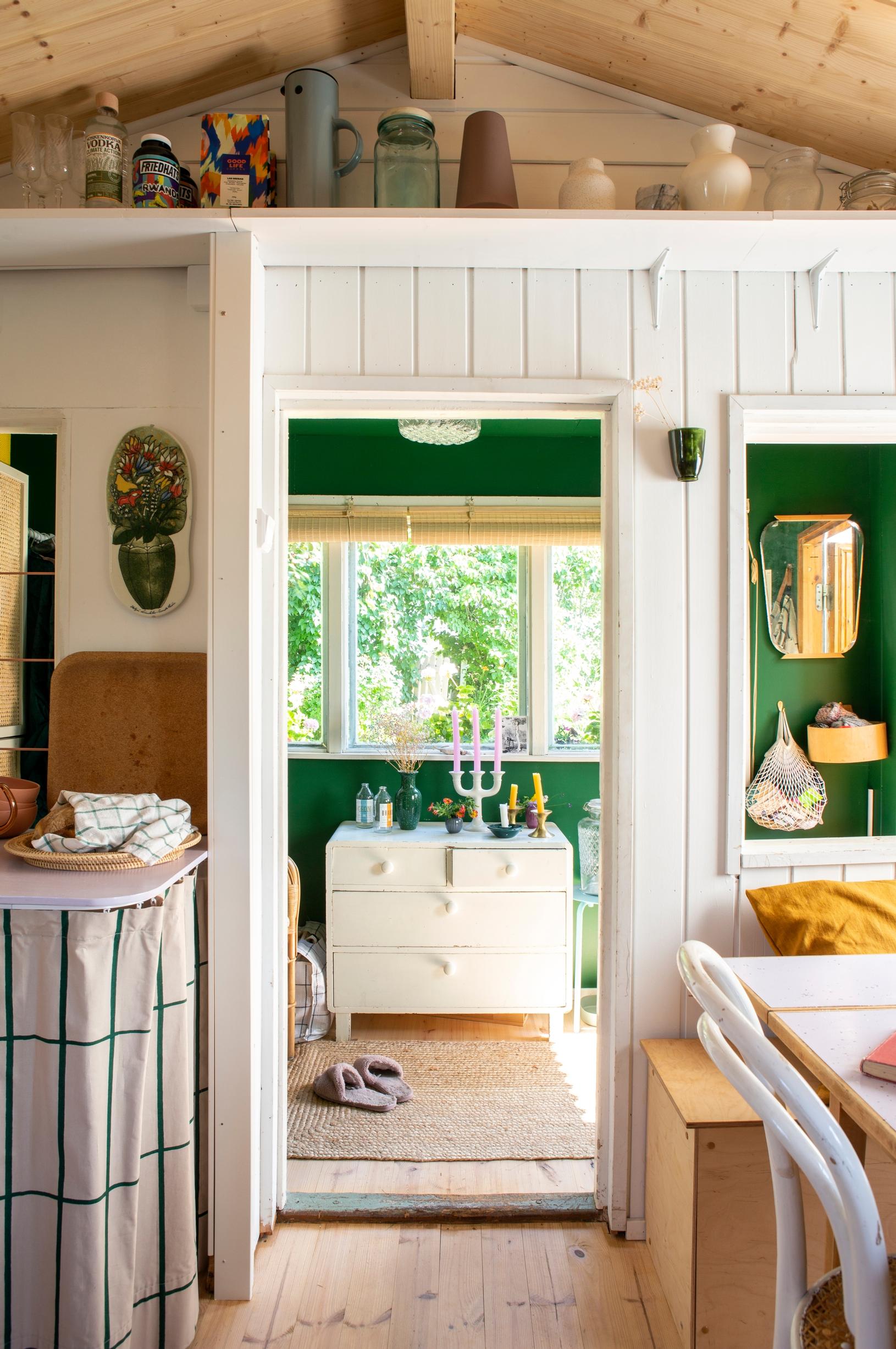 The green-painted entryway of the community garden cottage