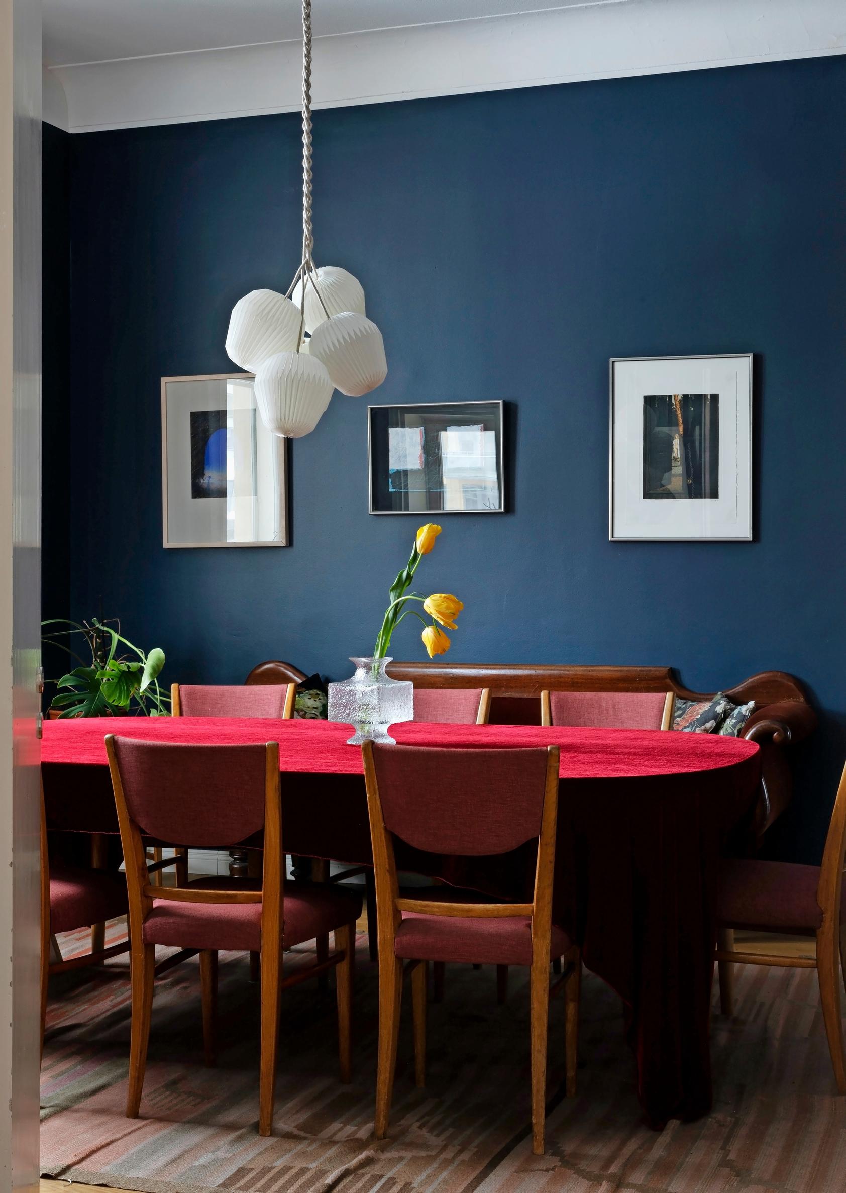 A dining table surrounded by six small chairs.