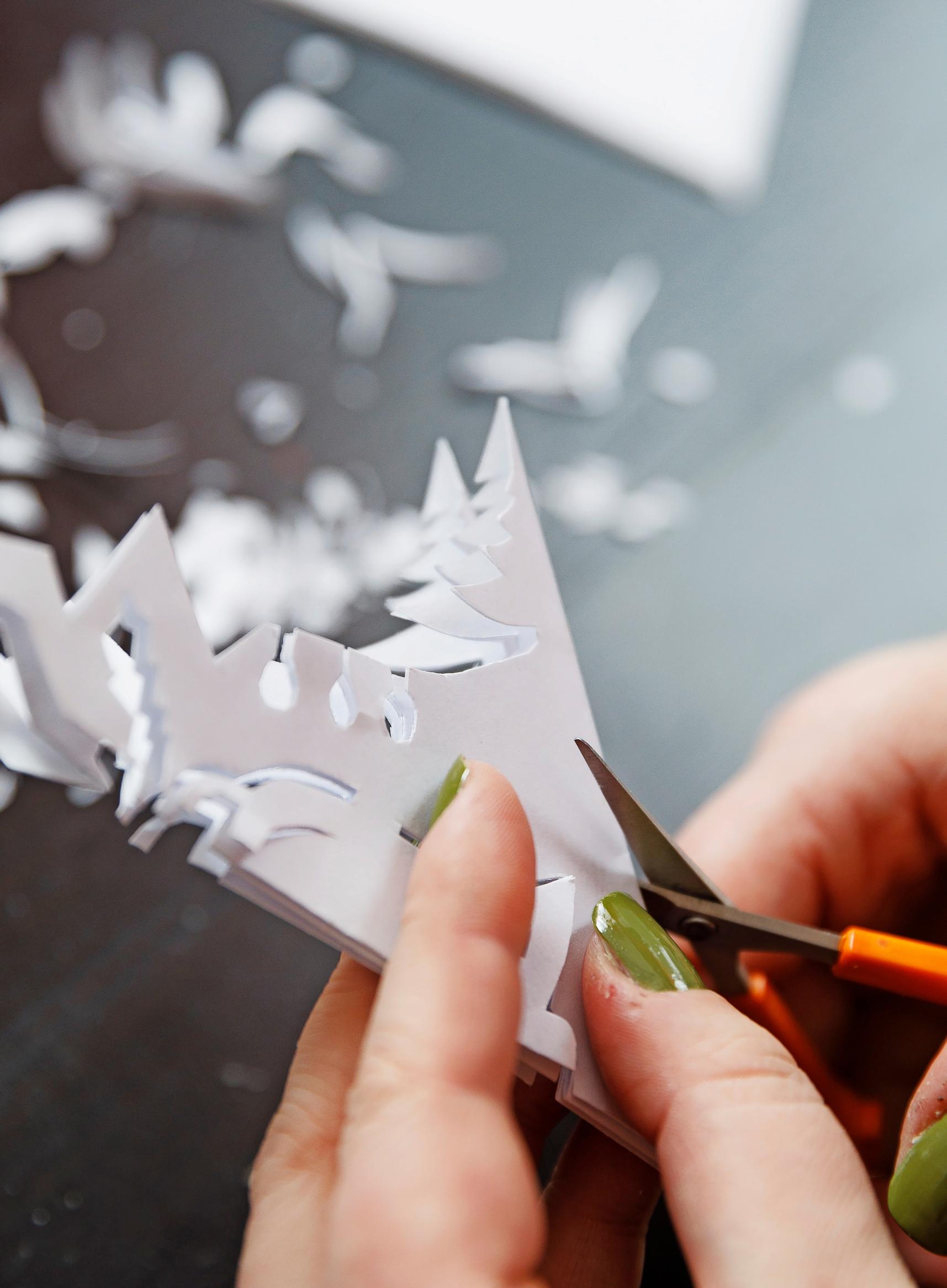 Venla cutting a paper star.