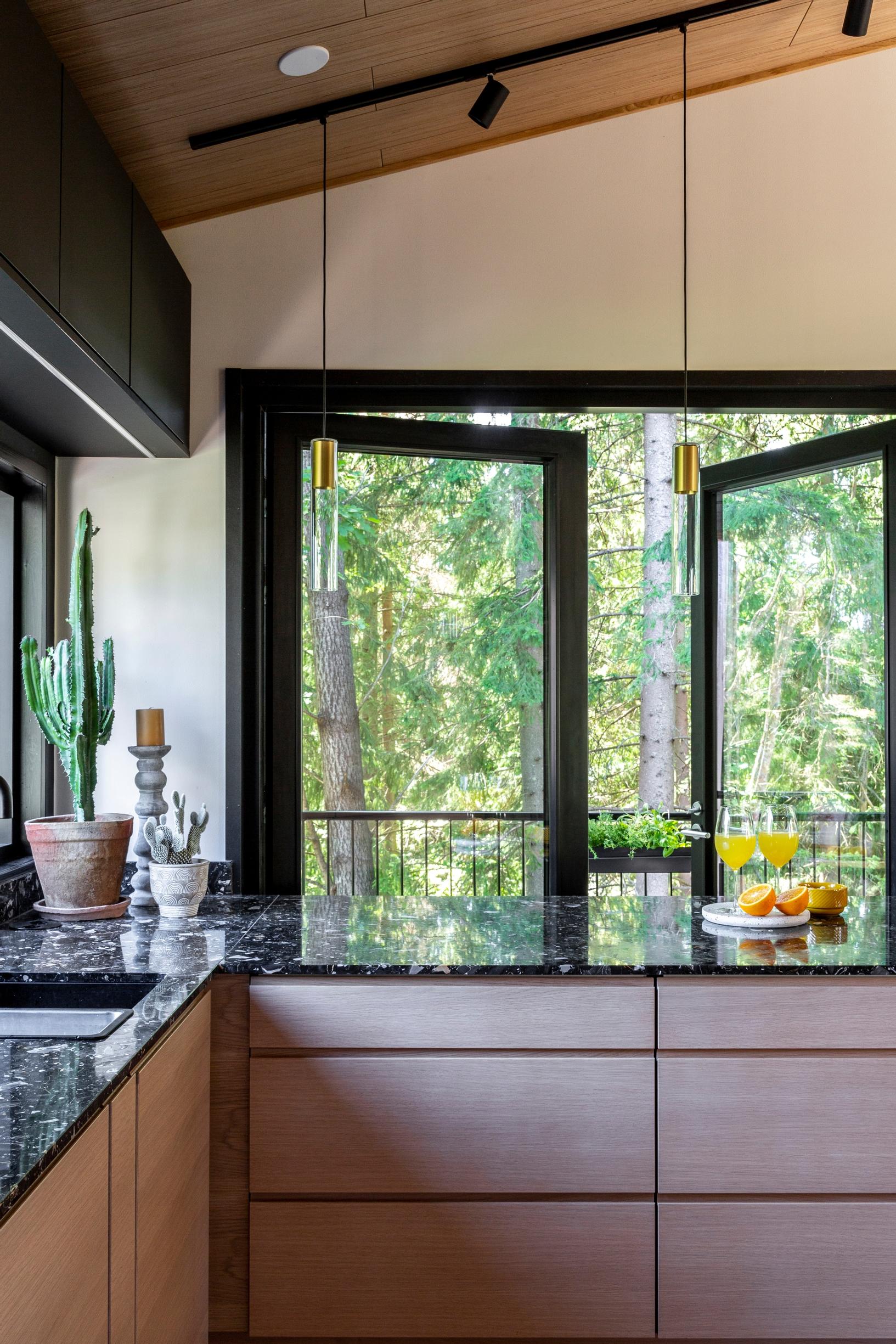 Behind the kitchen breakfast bar, windowed doors lead out onto the terrace.