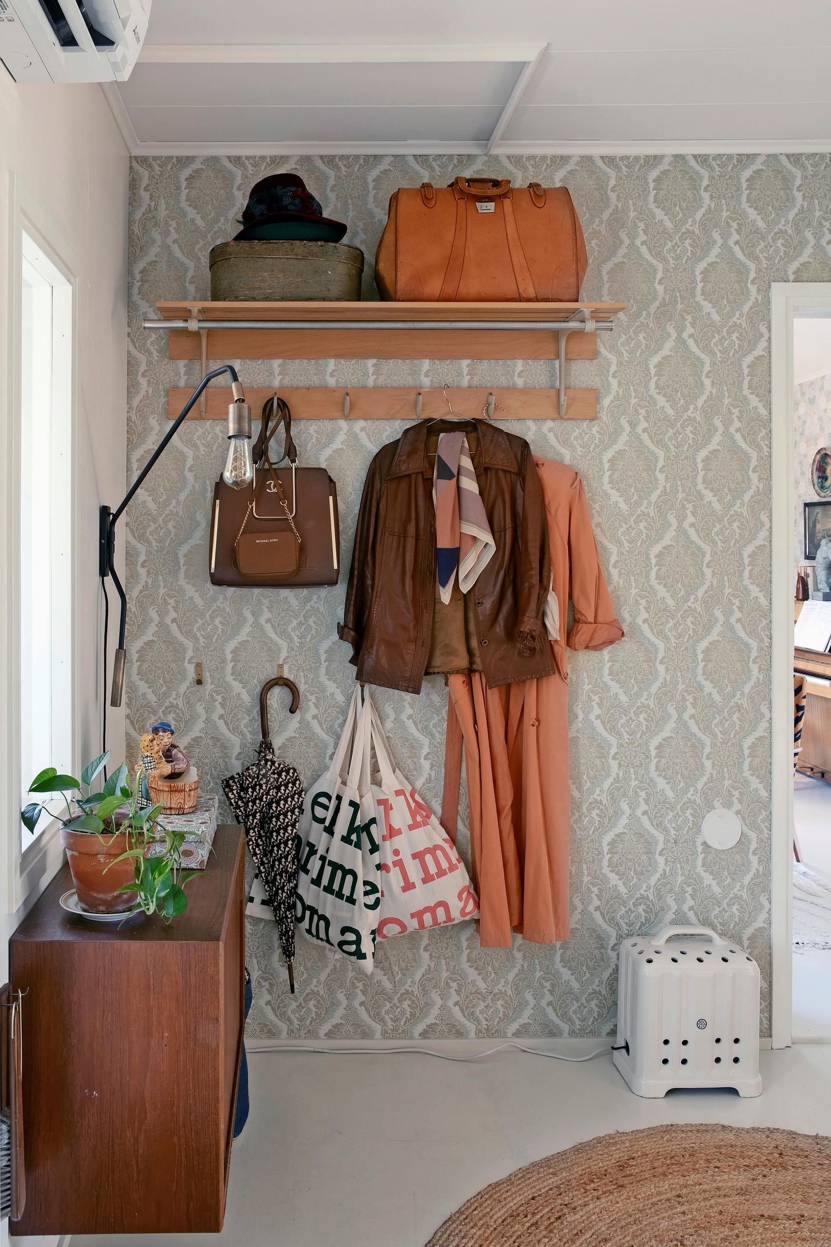 A wooden coat rack in an old house.