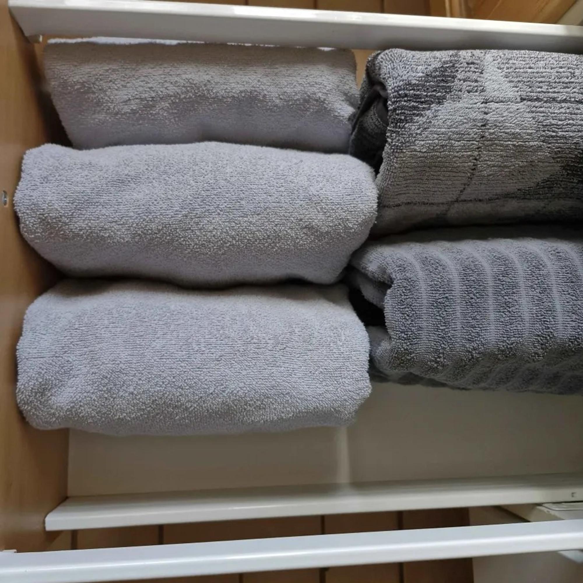 five gray towels in a cardboard box