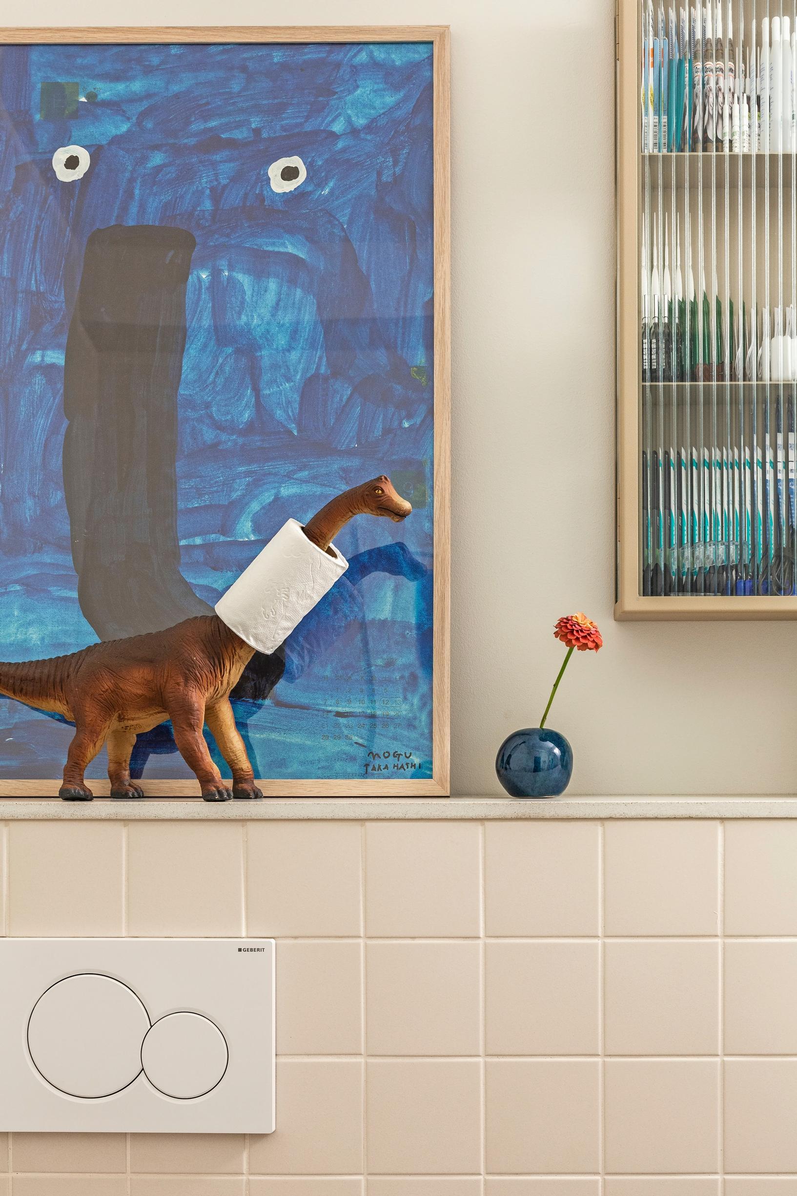 Toilet paper on a dinosaur’s neck