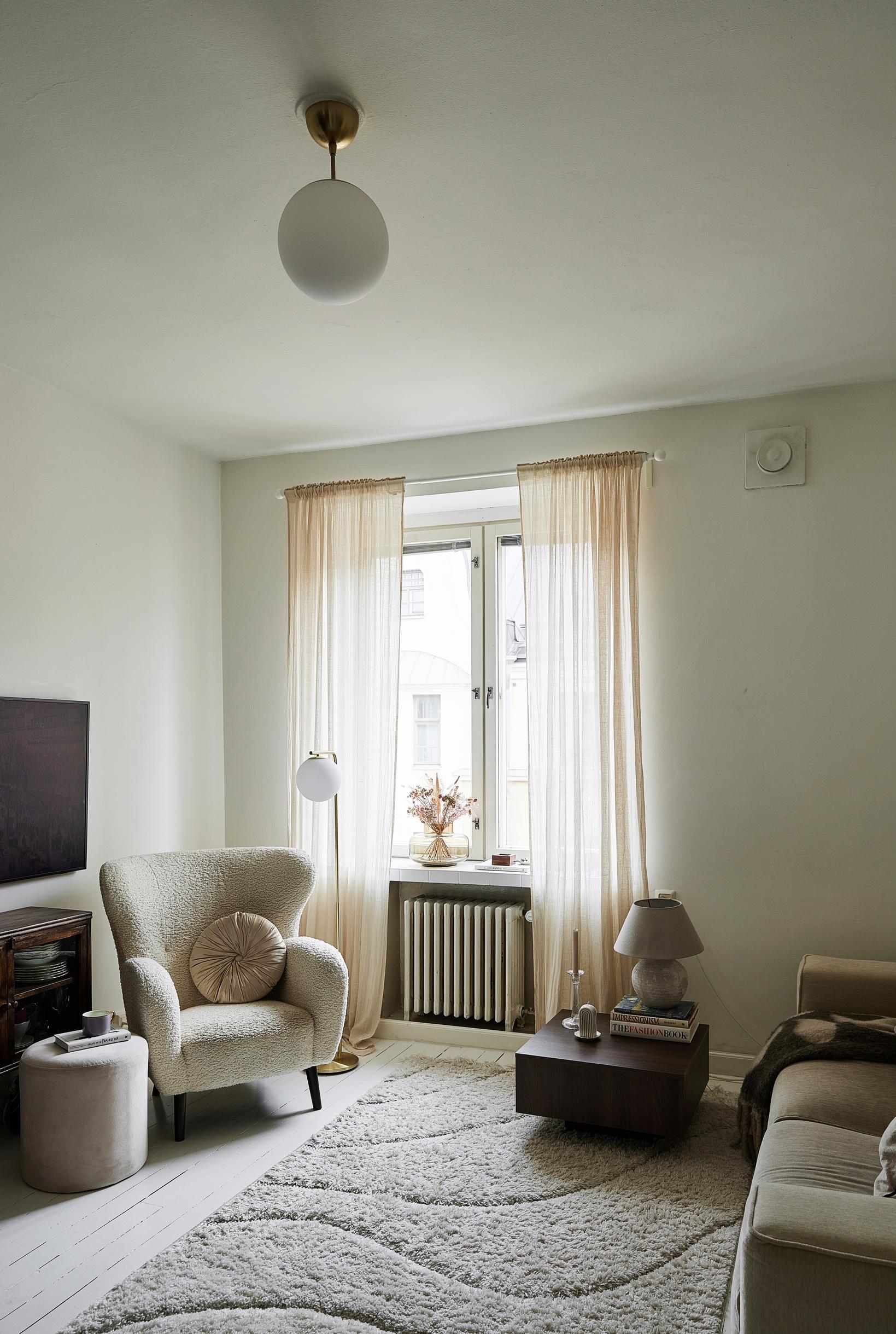 A living room with an armchair by the window