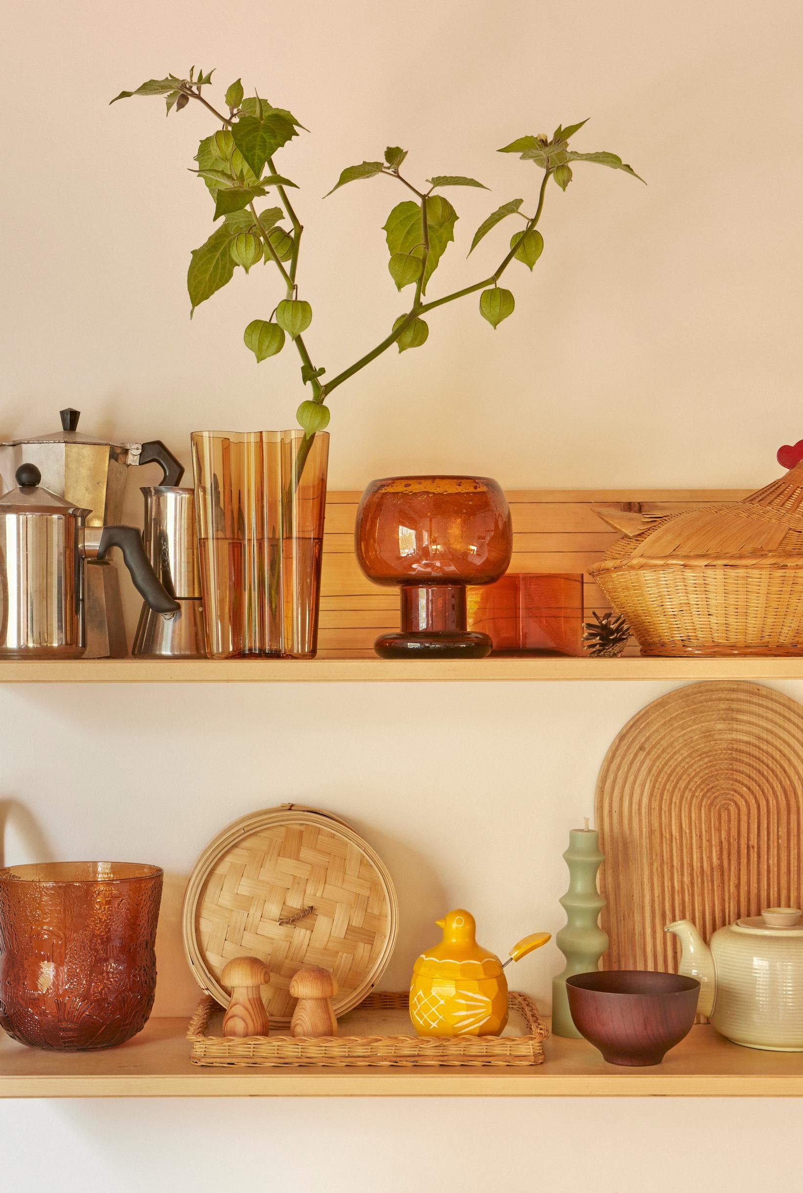 A variety of dishes and collectibles on Artek shelves.