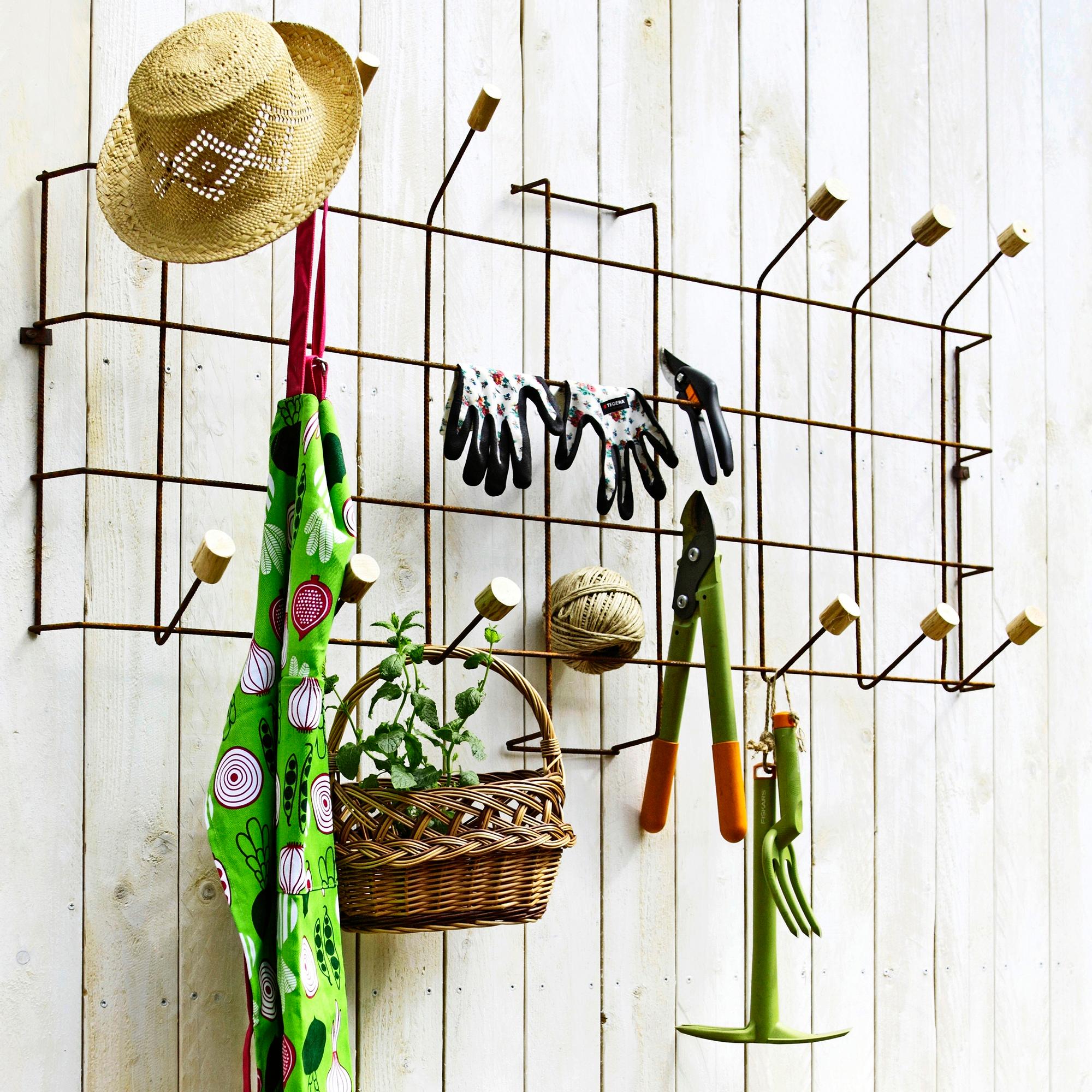 DIY wire mesh tool organizer stands up to any weather—hang your yard tools conveniently on the wall