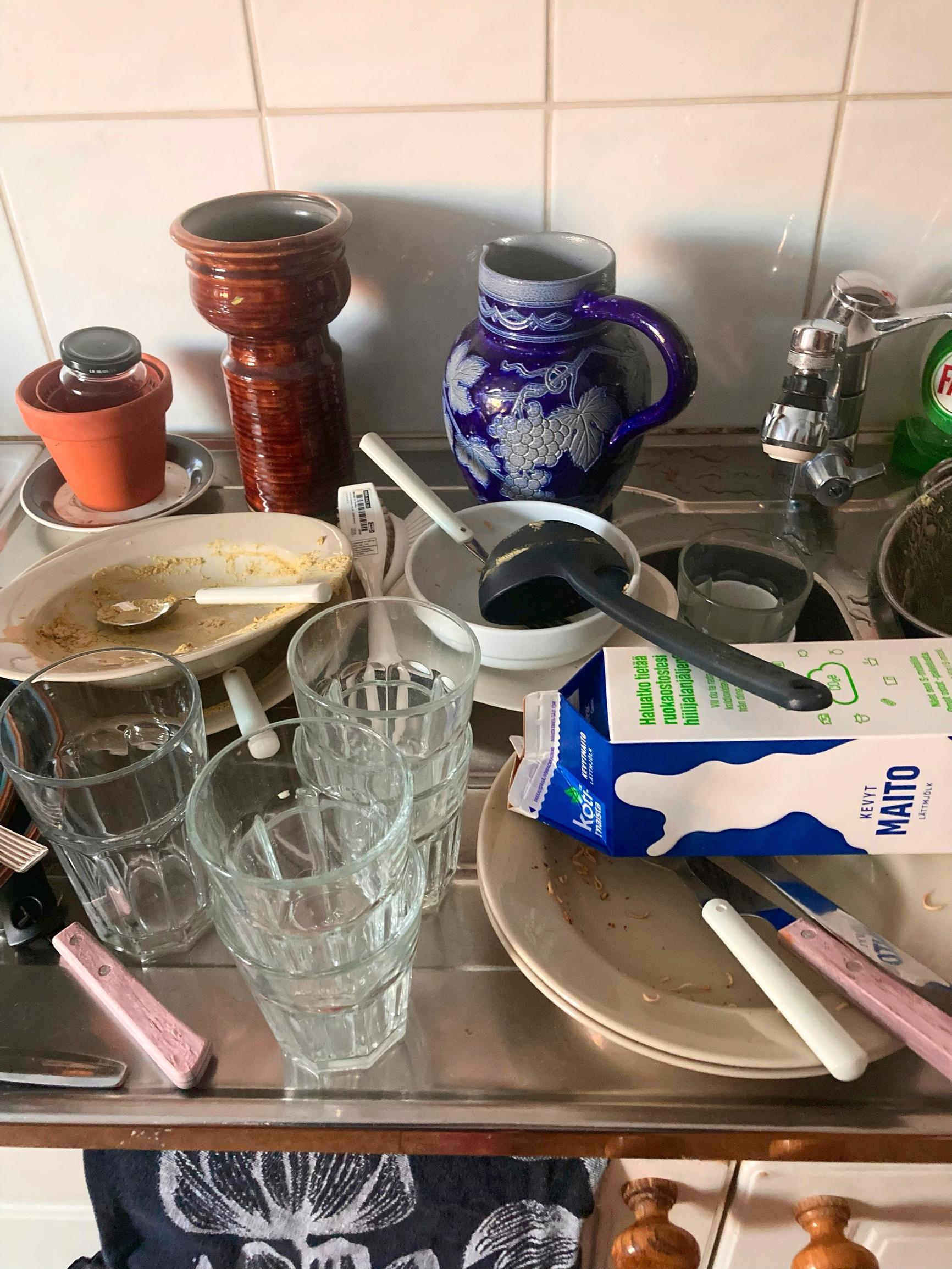 kitchen counter covered with dirty dishes
