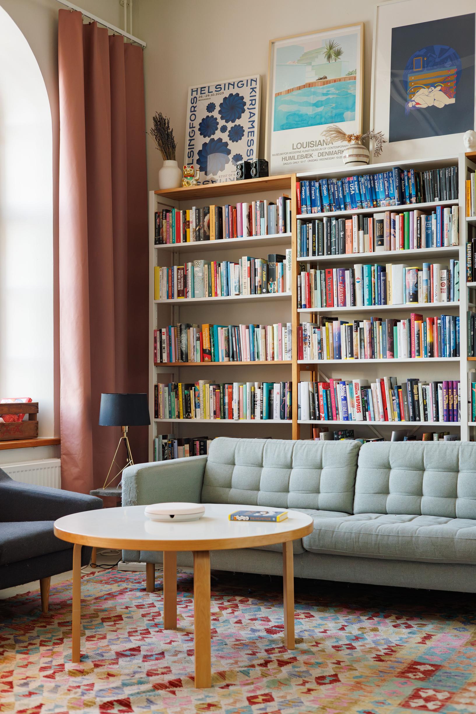 a bookshelf and a sofa in the living room